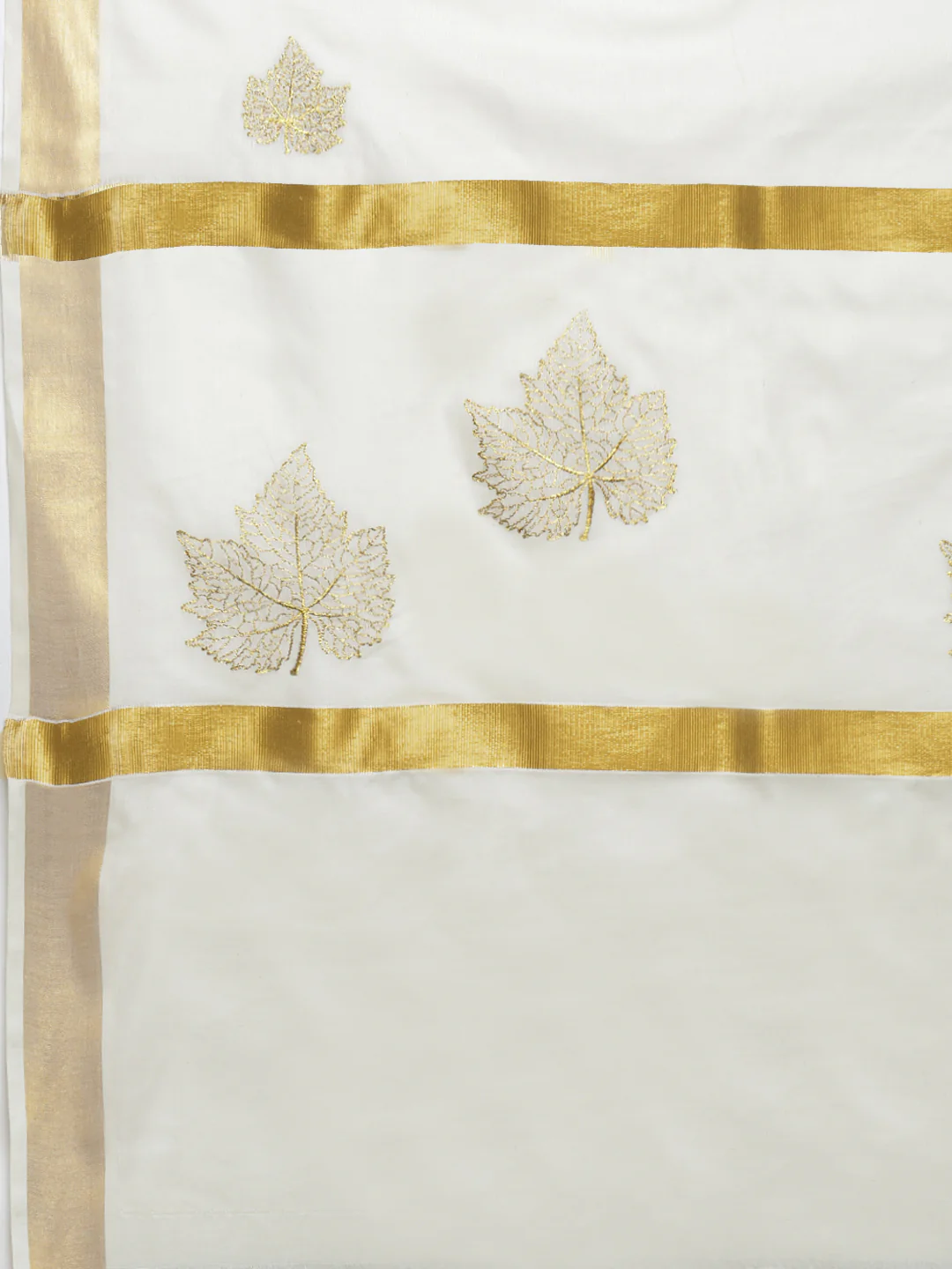 Elegant white Onam saree with golden embroidery and leaf motifs, perfect for festive celebrations