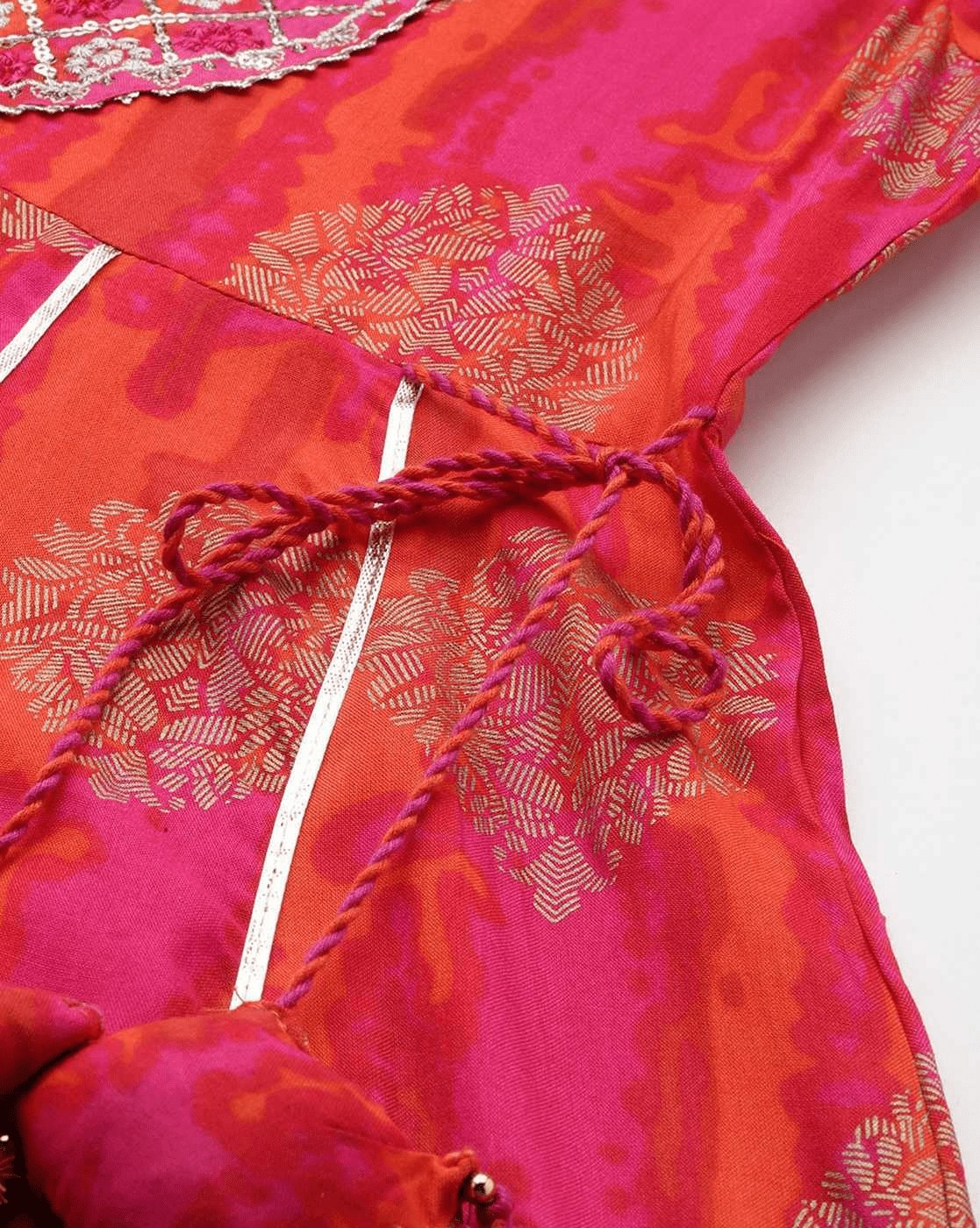 Close-up of the orange rayon Anarkali set featuring intricate floral patterns and decorative ties