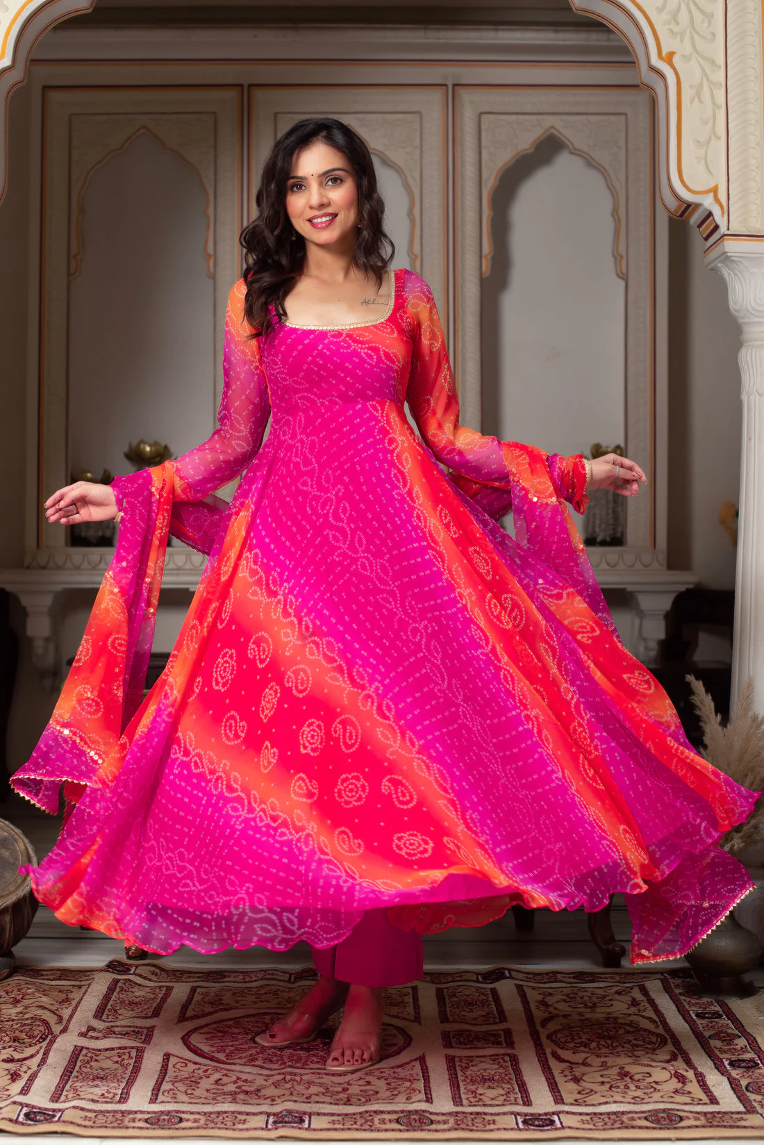 Front view of a pink Bandhani Anarkali suit Canada made from lightweight fabric, perfect for weddings or festive occasions