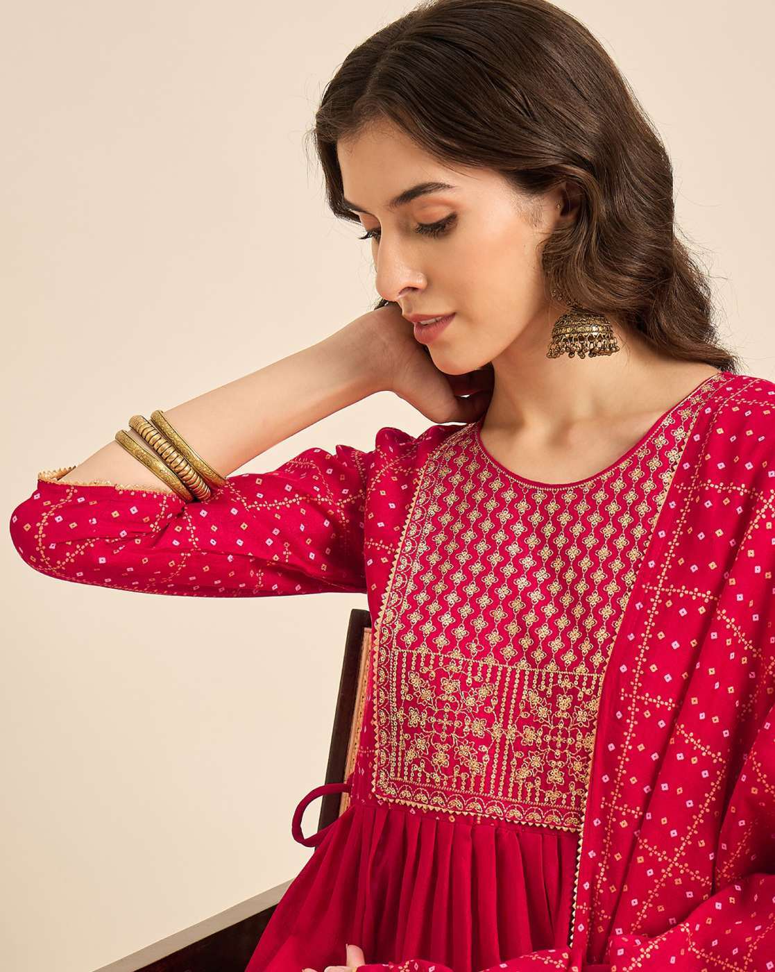 Model wearing a pink embroidered kurta set featuring intricate embroidery and elegant details