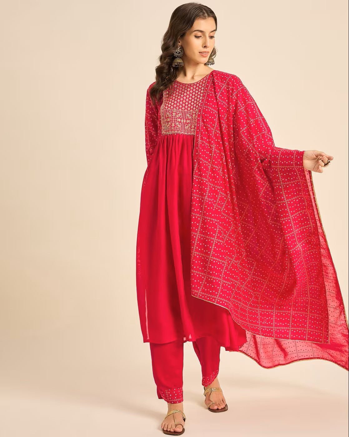 Elegant pink embroidered kurta set with intricate designs and matching trousers for festive occasions