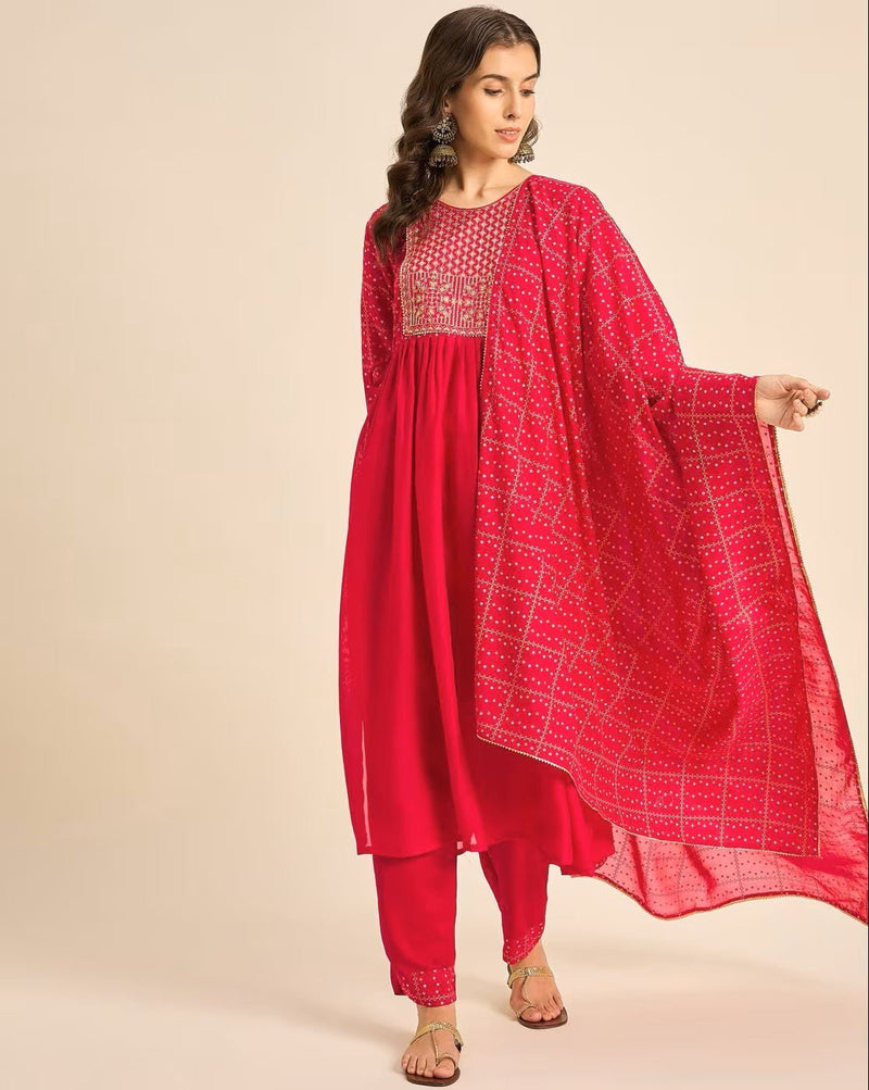 Elegant pink embroidered kurta set with intricate designs and matching trousers for festive occasions