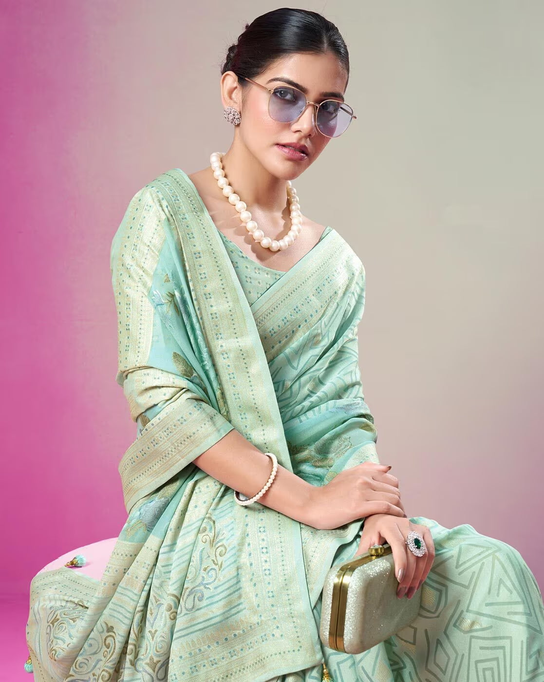 Elegant woman wearing a printed cotton casual saree in pastel green with intricate patterns