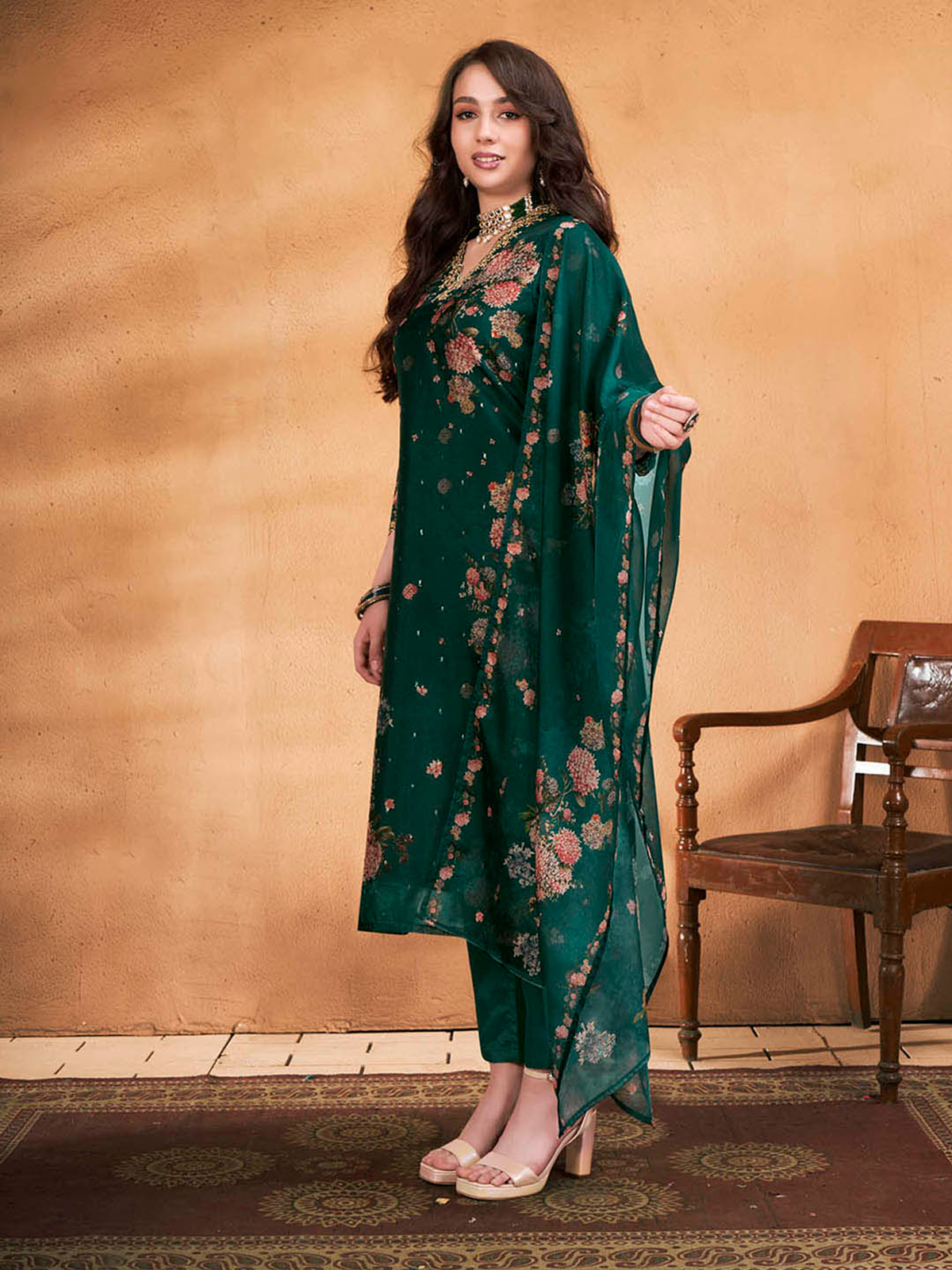 Elegant woman wearing a three piece purple floral cotton kurta set with embroidered details and matching accessories