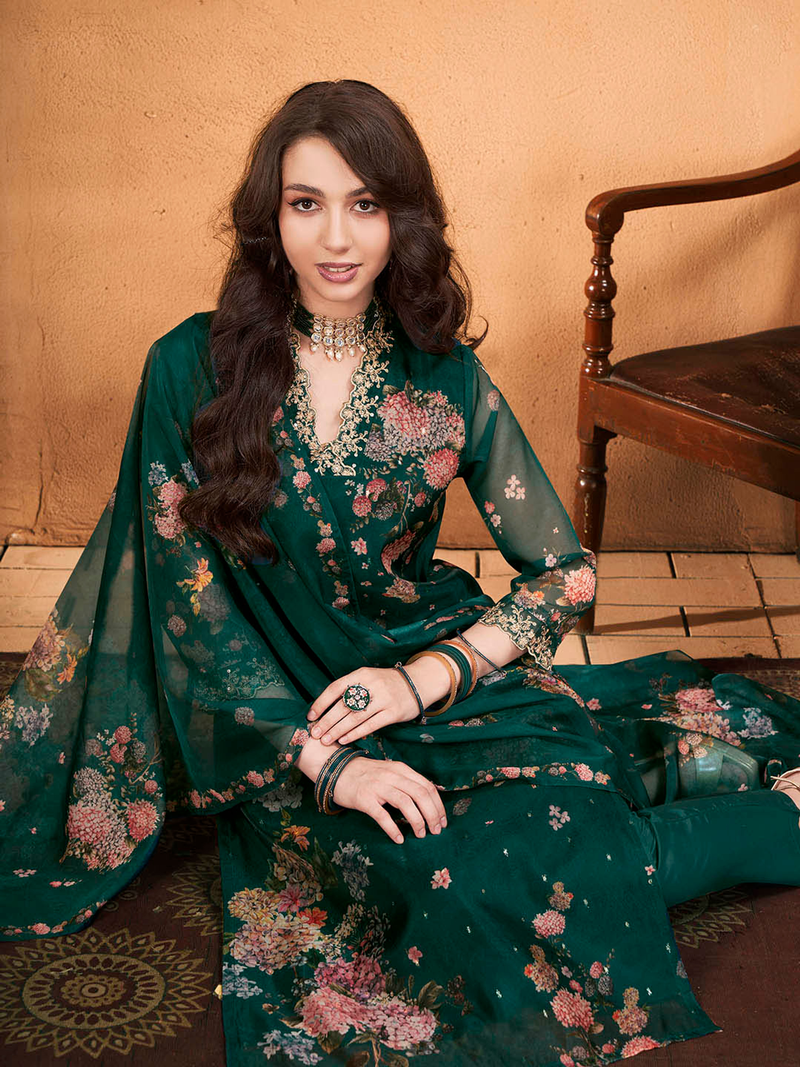 Elegant purple floral cotton kurta set styled with matching accessories and seated on a vintage chair