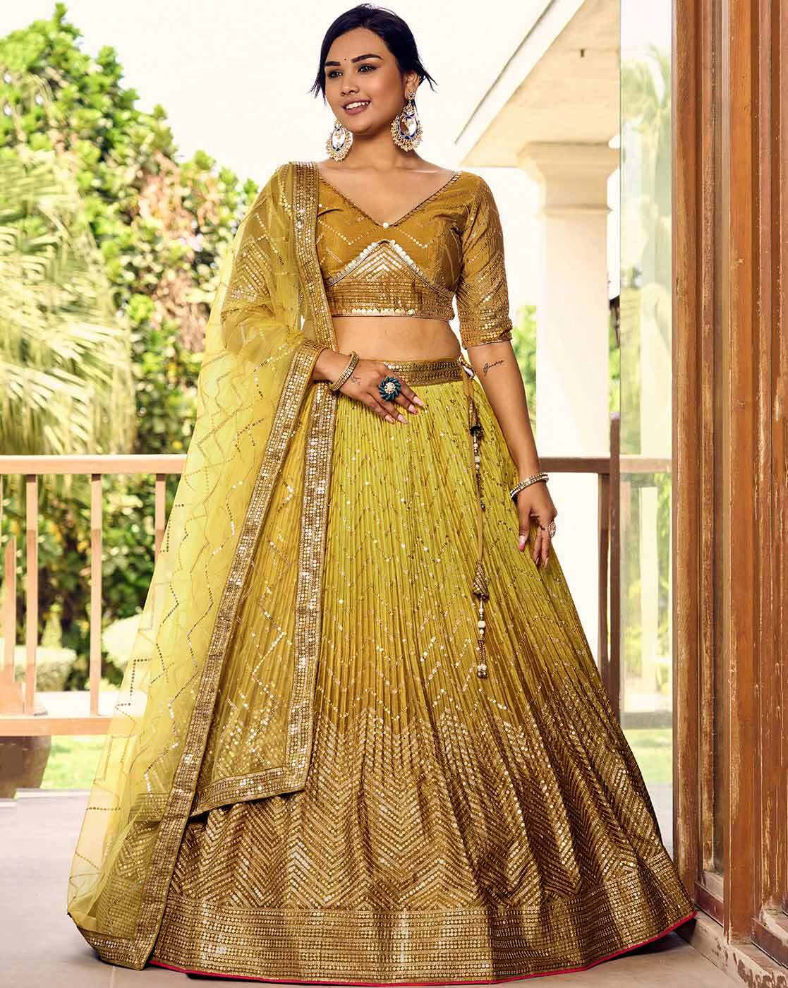 Gold mustard embellished flared lehenga choli Canada with sequined blouse and dupatta on model outdoors
