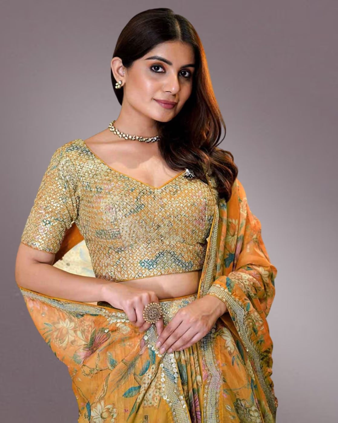 Young woman modeling a mustard floral women embroidered lehenga choli set with sequin blouse and dupatta
