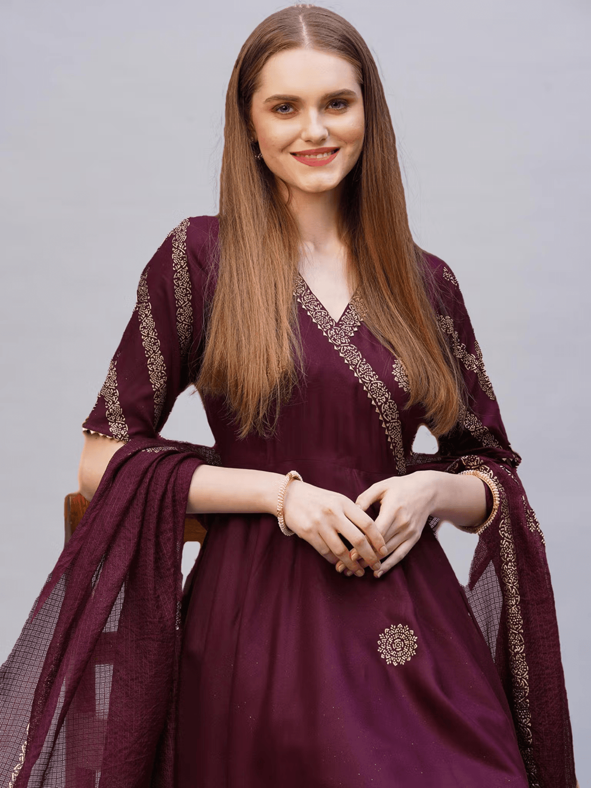 Elegant Rayon Anarkali Kurta Set in deep burgundy with intricate embellishments and soft flowing sleeves