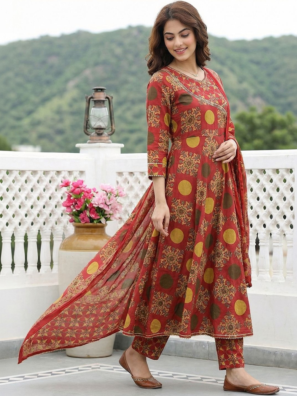 Red anarkali kurta set with dupatta featuring floral and circular patterns, ideal for festive occasions.