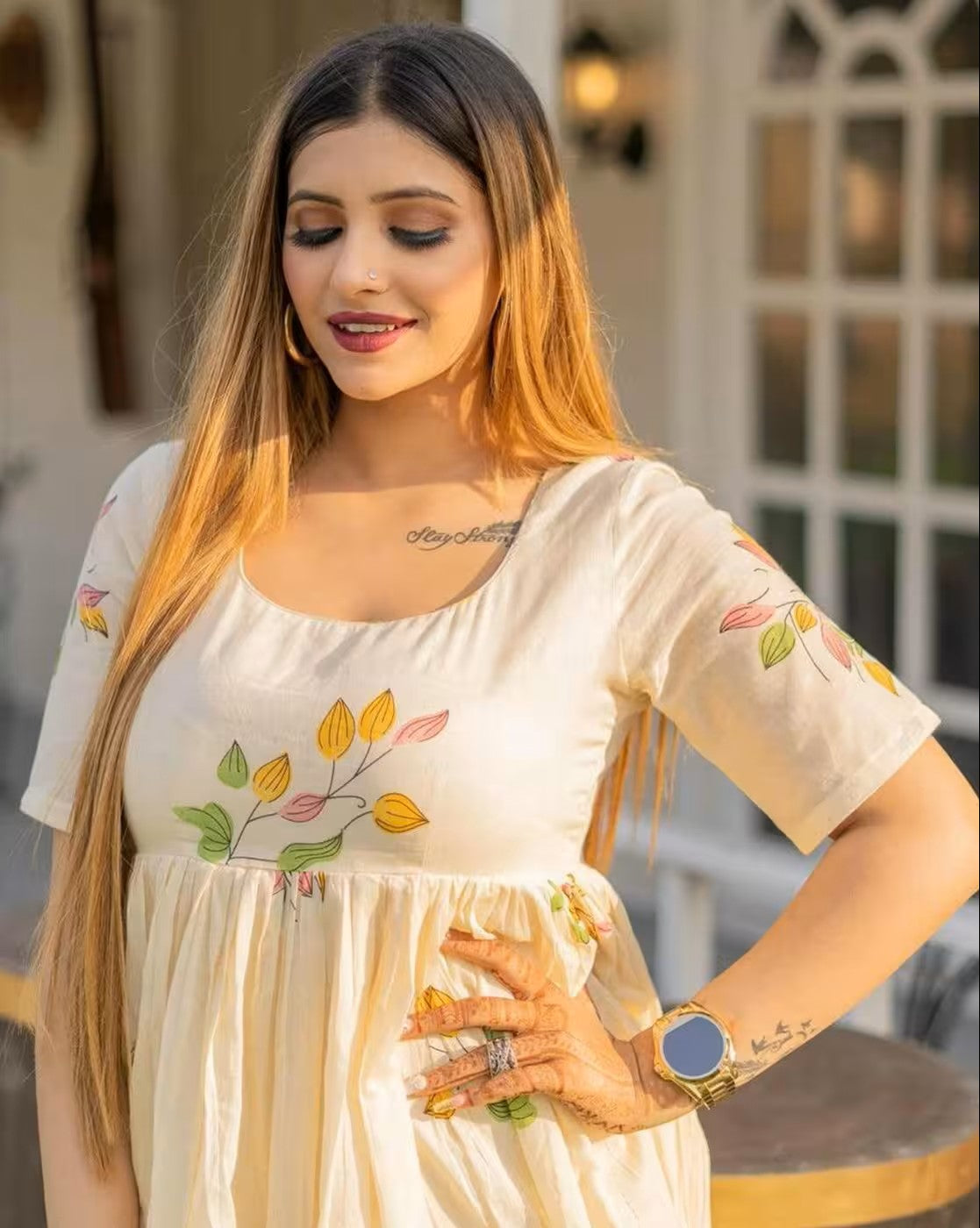 Woman wearing a cream mini dress with floral designs, not a rust orange mini dress by aromie