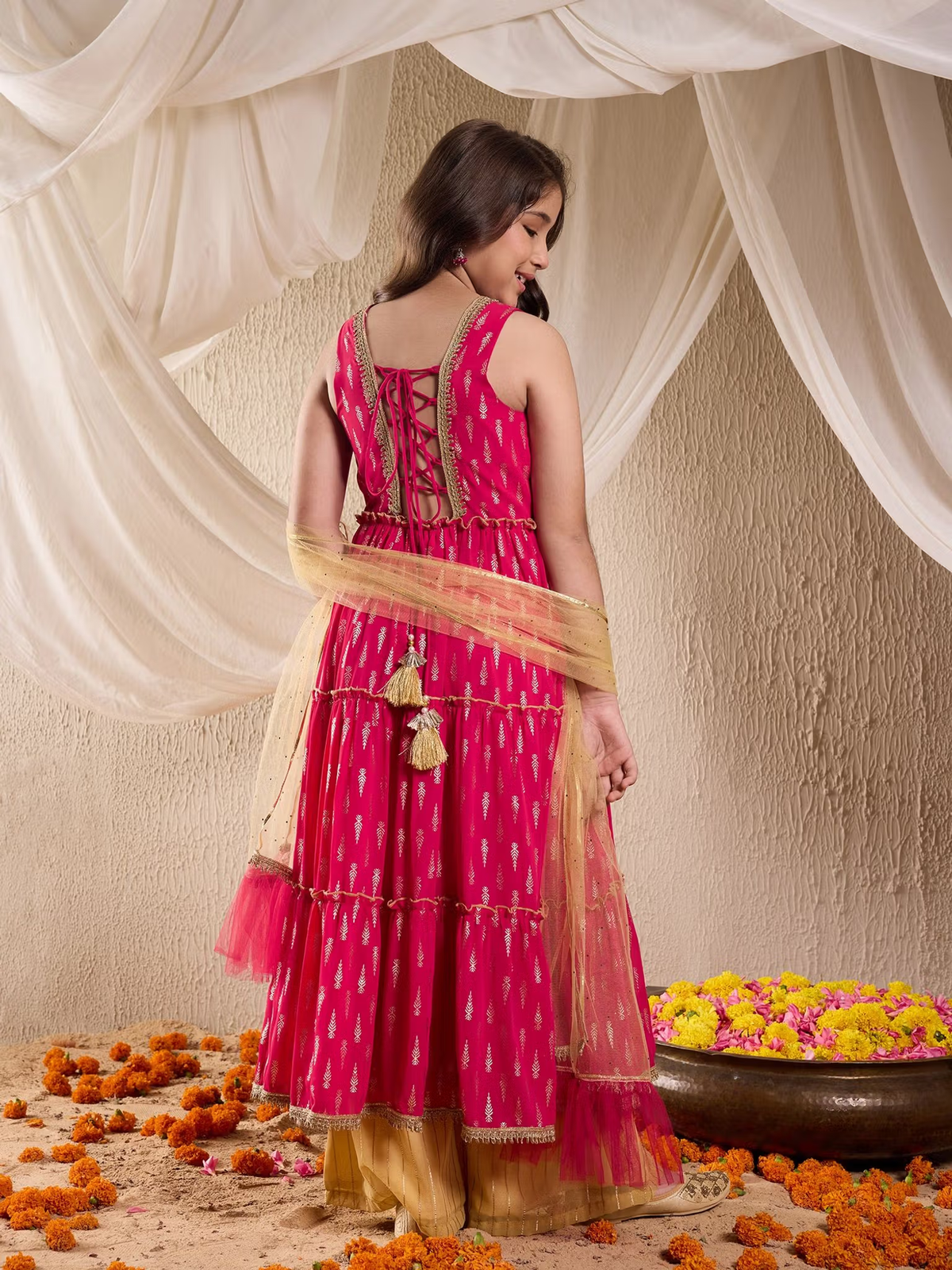 Back view woman wearing fuchsia tiered kurta with lace up back gold palazzo and dupatta Indian kurta palazzo dupatta set Canada