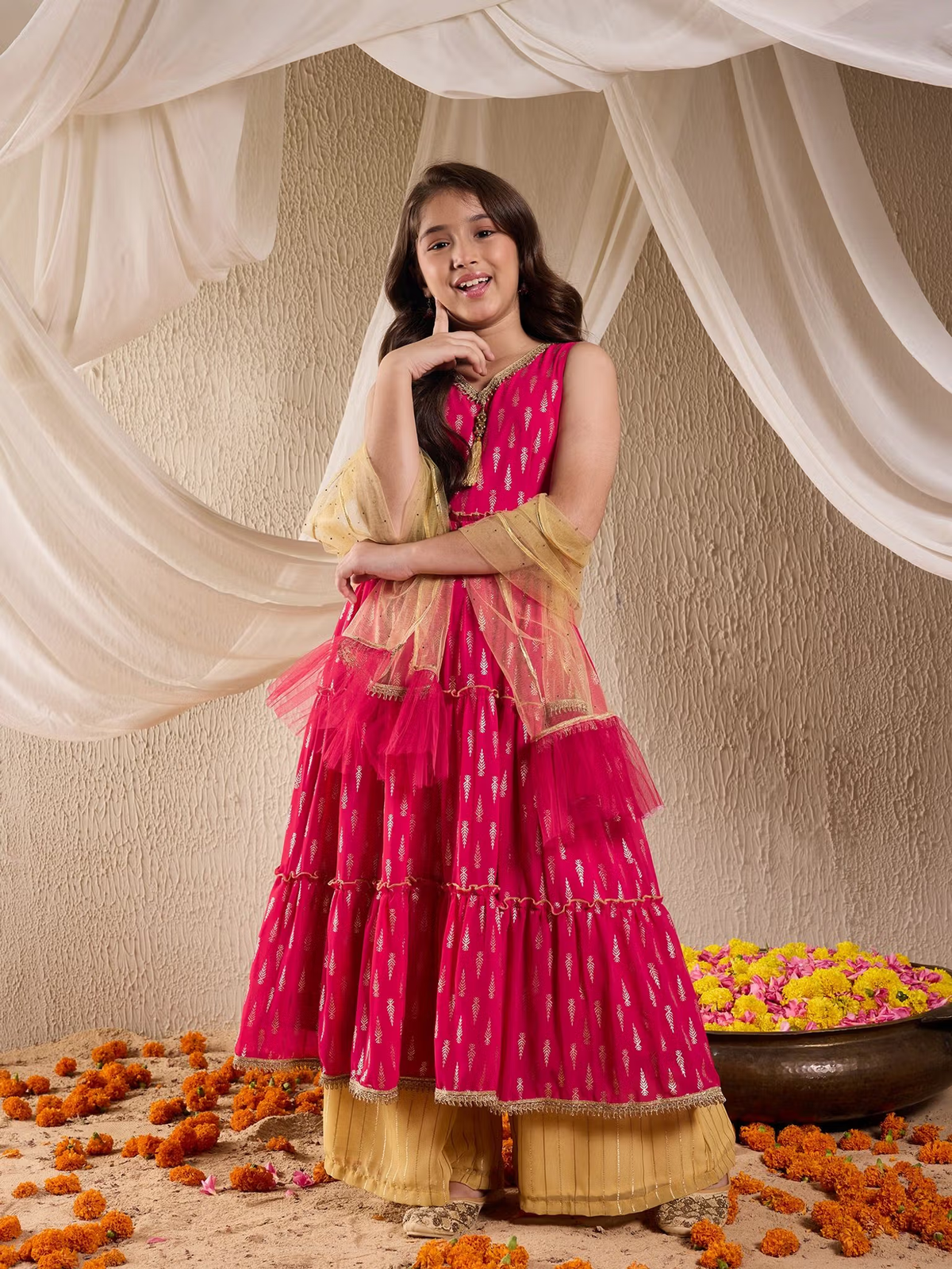 Young woman in fuchsia tiered kurta with gold palazzo and sheer dupatta marigold decor Indian kurta palazzo dupatta set Canada