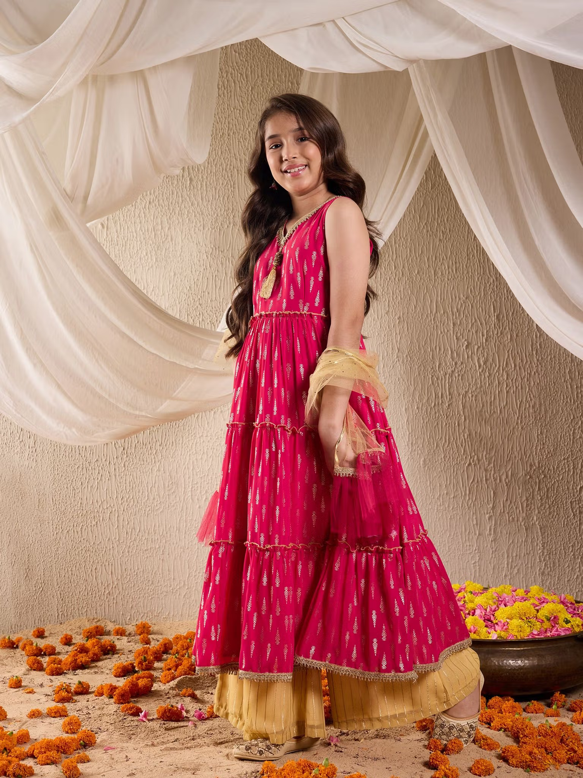Young woman in bright pink tiered kurta with mustard palazzo and dupatta among marigolds Indian kurta palazzo dupatta set Canada