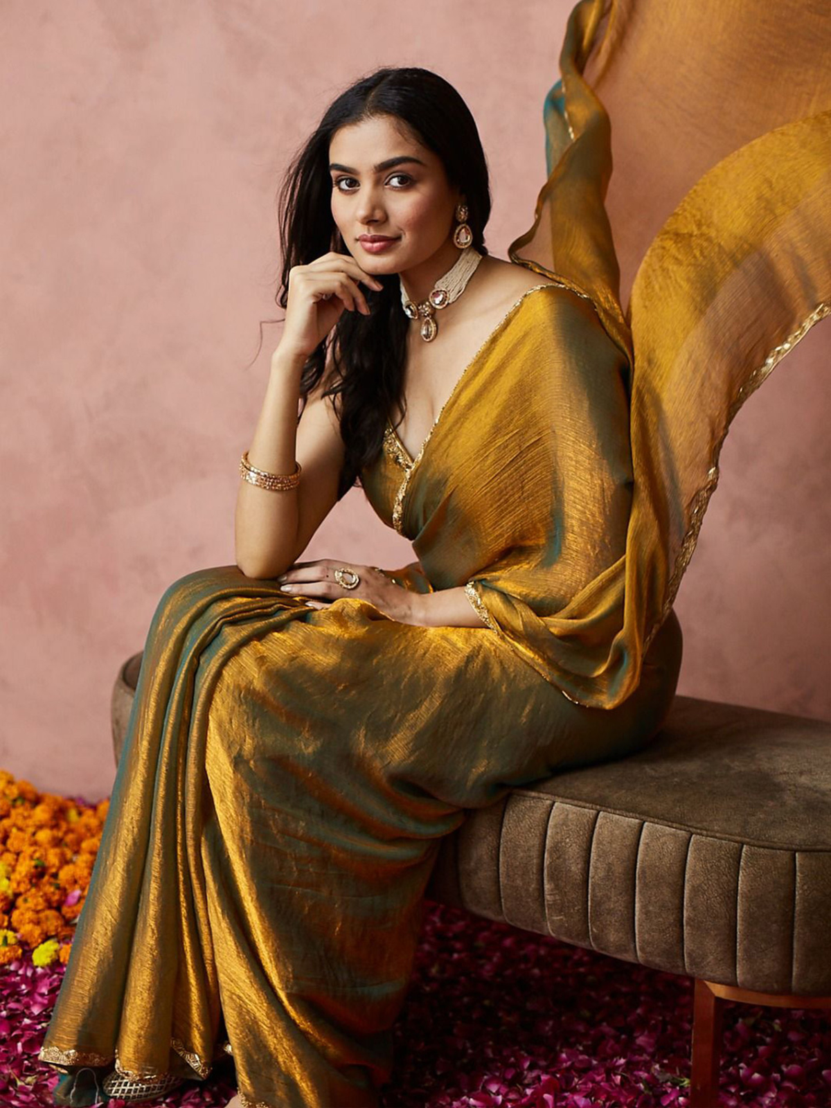 Elegant gold-toned saree in lightweight fabric, perfect for weddings, displayed in front view on a model