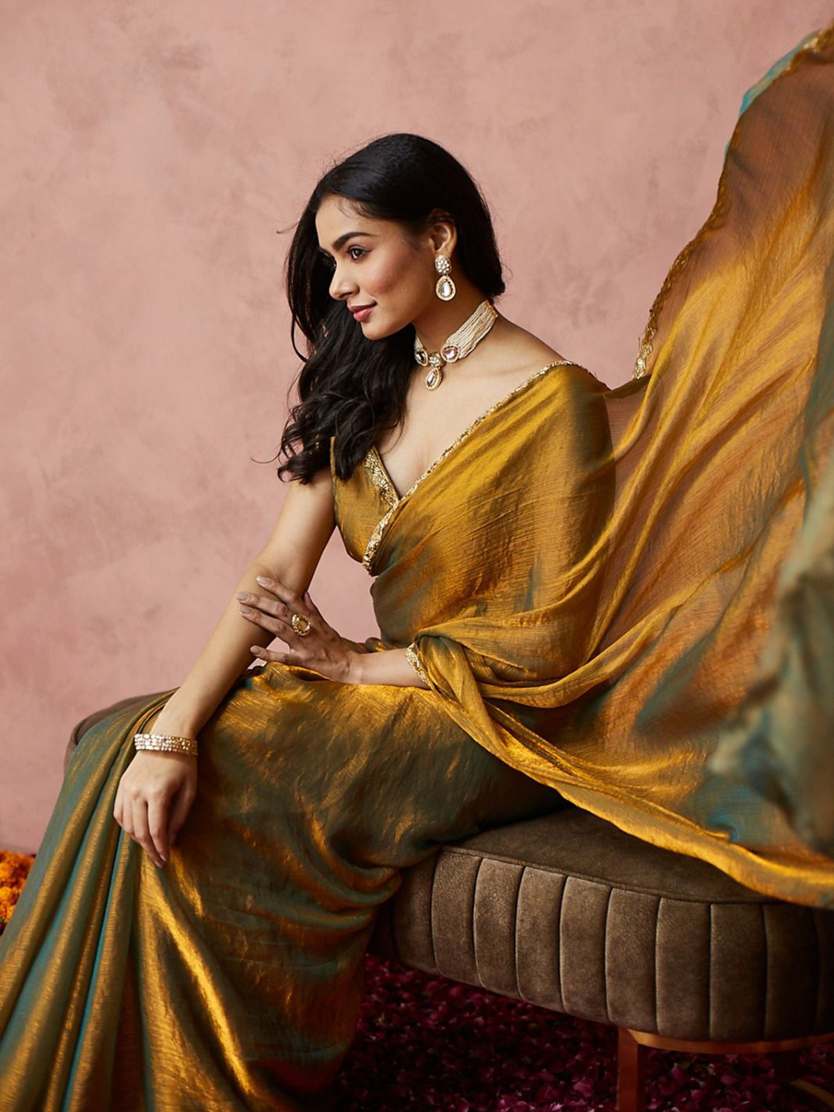 Gold-toned saree by Aromie in silk fabric, shown draped elegantly for festive occasions