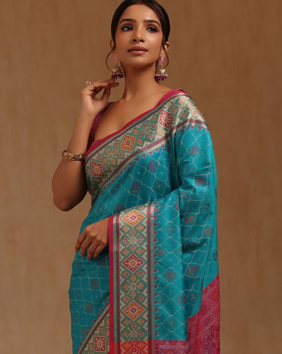 Elegant turquoise saree with intricate patterns designed for festive occasions, available for purchase as saree online Canada.