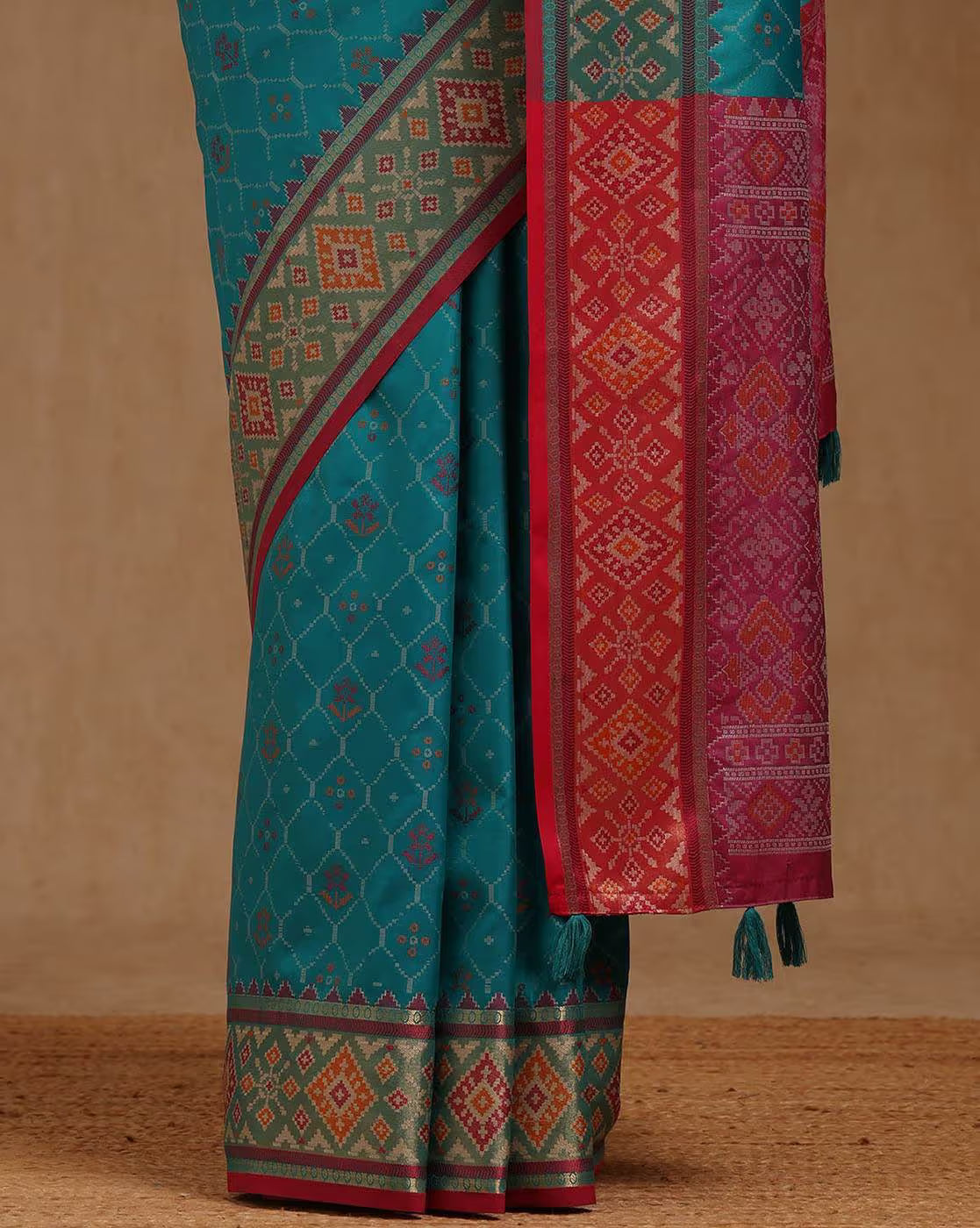 Elegant turquoise saree with intricate patterns and a contrasting red border, perfect for weddings. Saree online Canada.