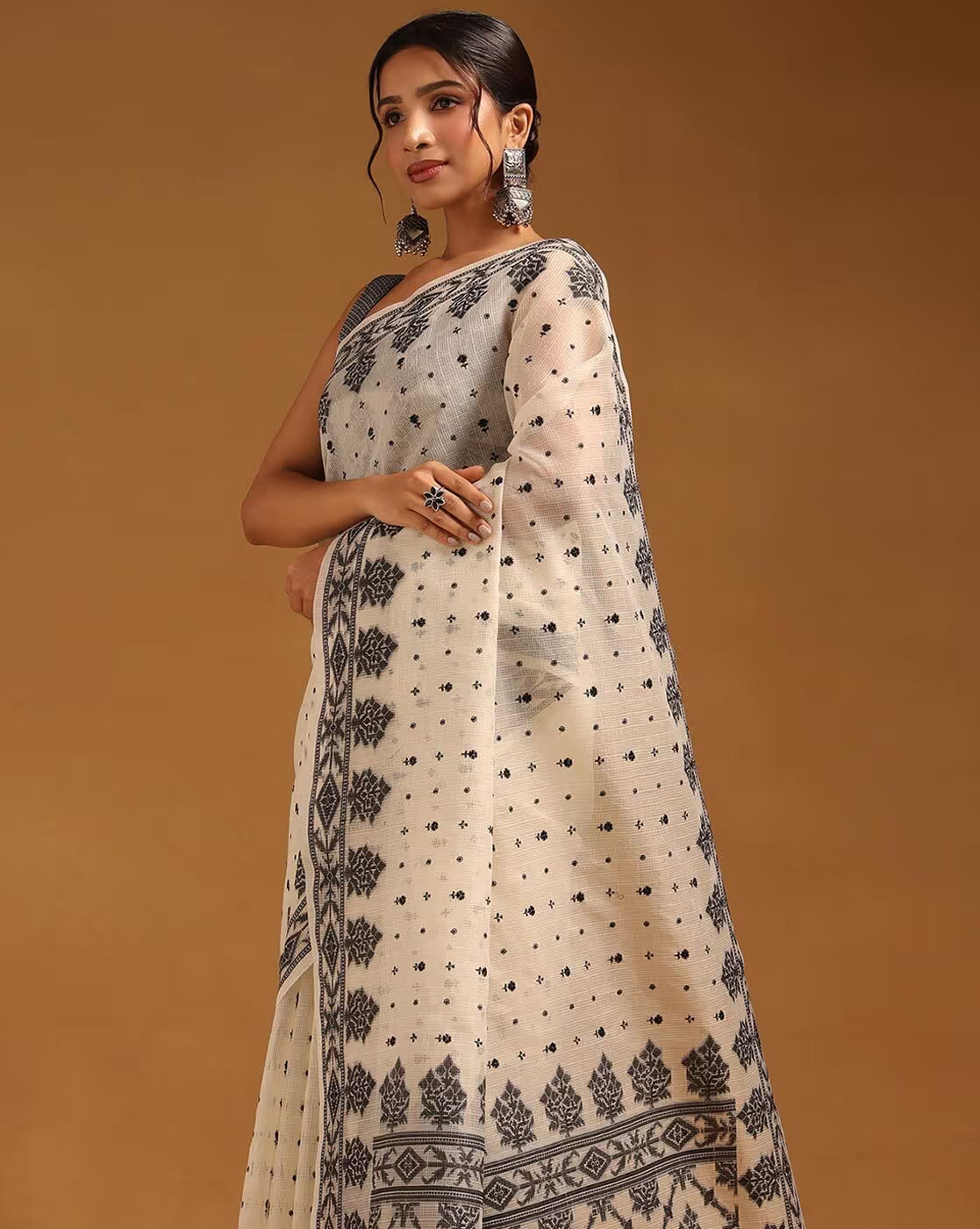 Elegant cream satin saree with intricate black designs, perfect for weddings and special occasions in Canada.