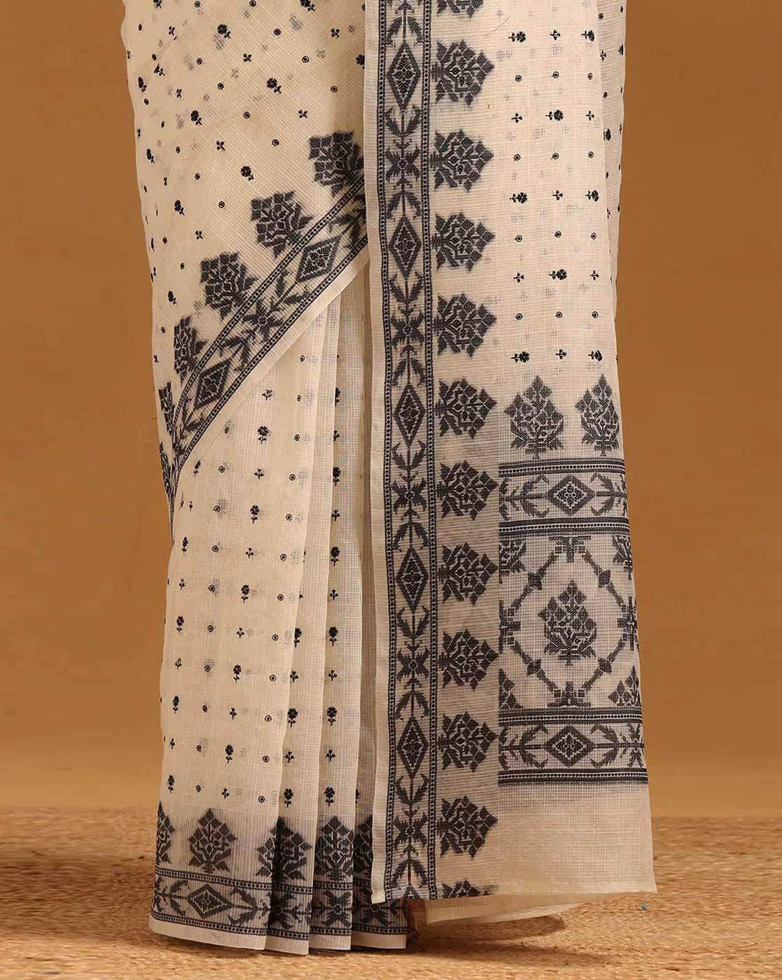 Elegant cream satin saree with intricate black patterns, perfect for weddings in Canada.