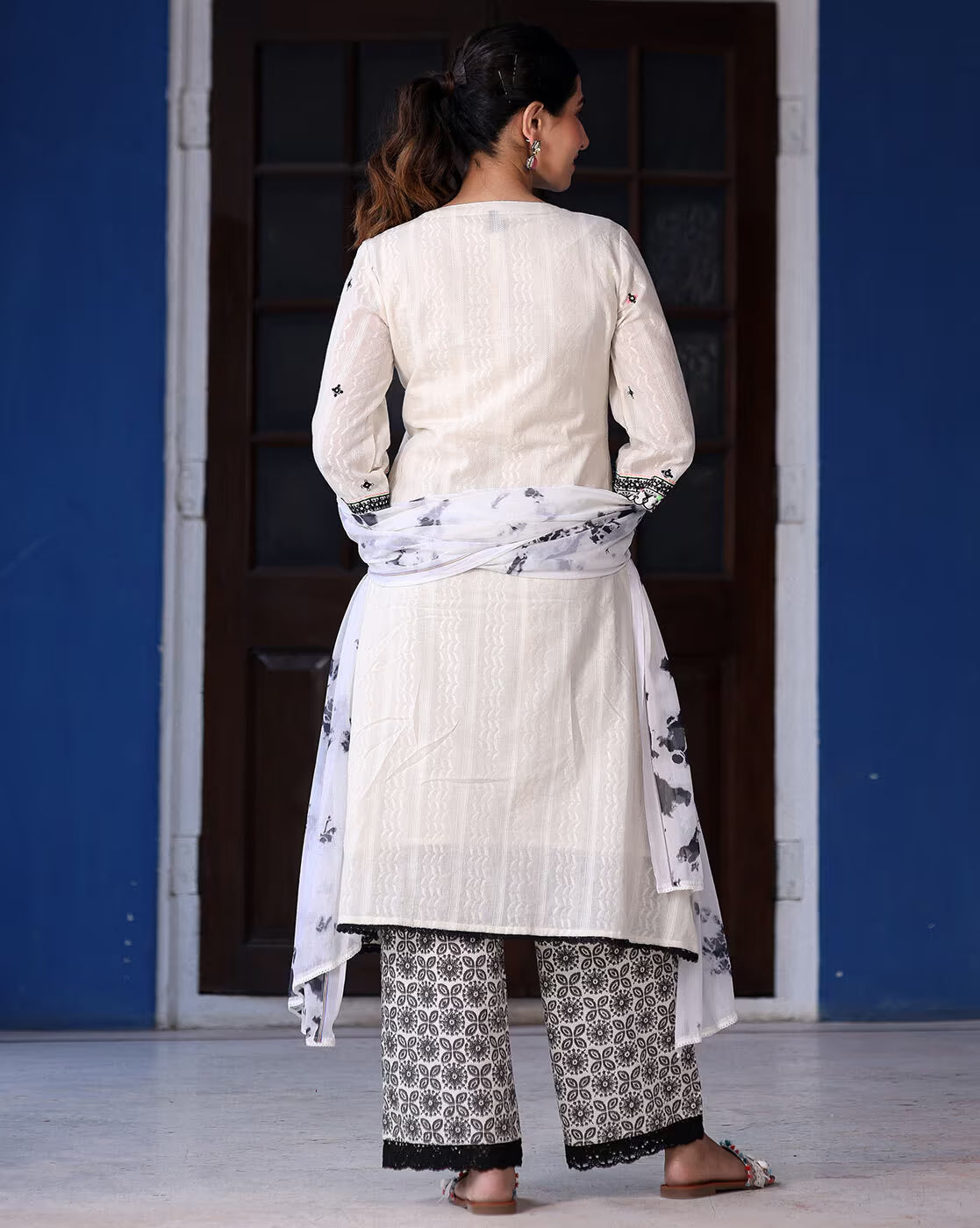 Back view of a sea green ethnic kurta set by Aromie featuring intricate patterns and a matching dupatta