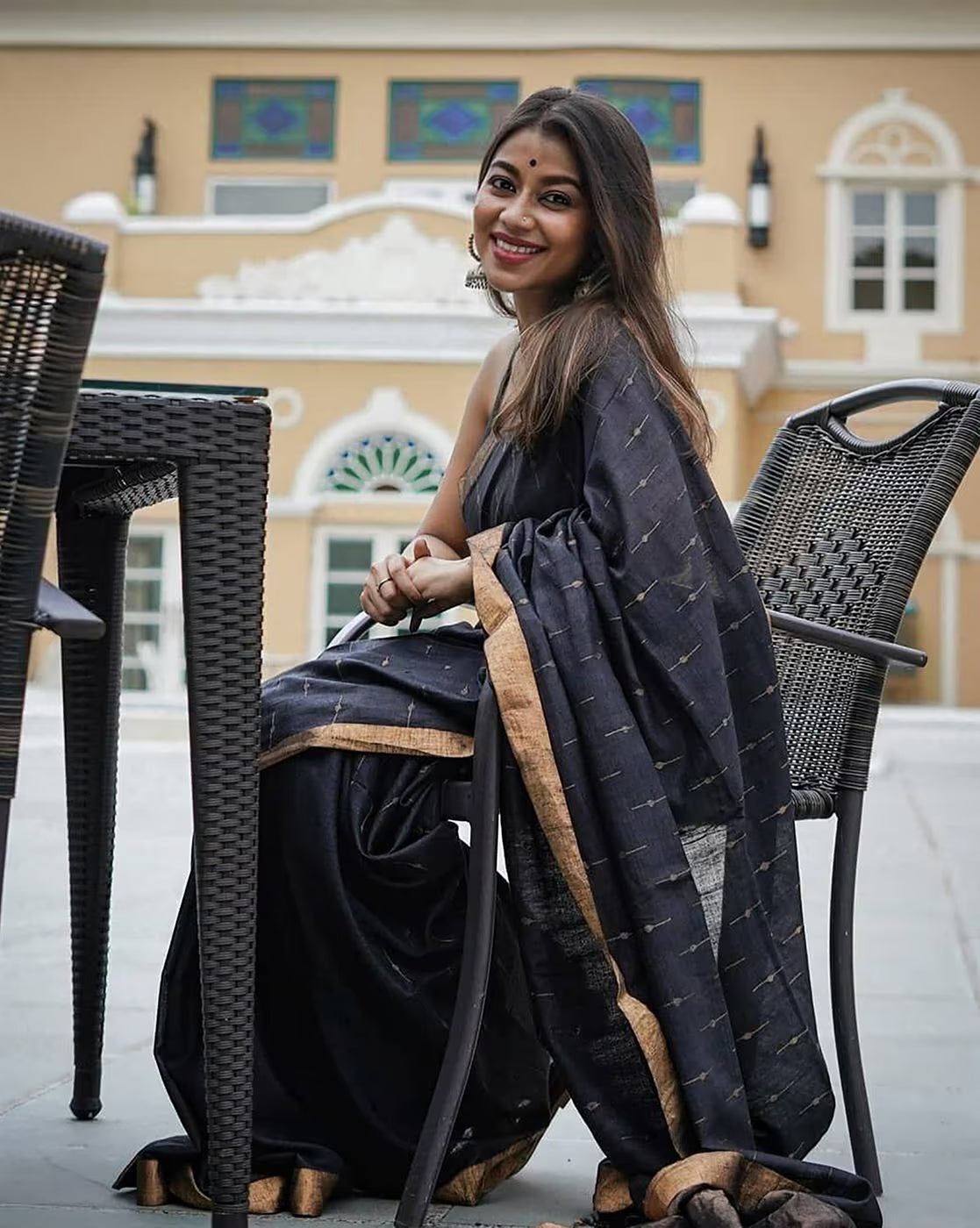 Elegant woman wearing a sequin embellished saree online with a stylish design and intricate details
