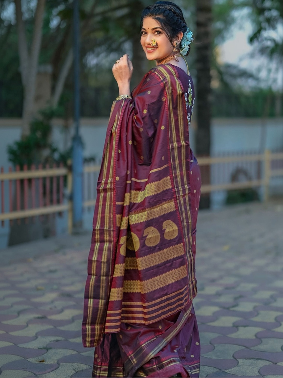 Front view of a maroon sequin embellished saree online made from lightweight fabric, perfect for festive occasions.