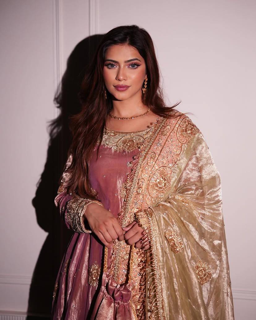 Front view of a sequin embroidered kurta pant set in soft pink silk for festive occasions