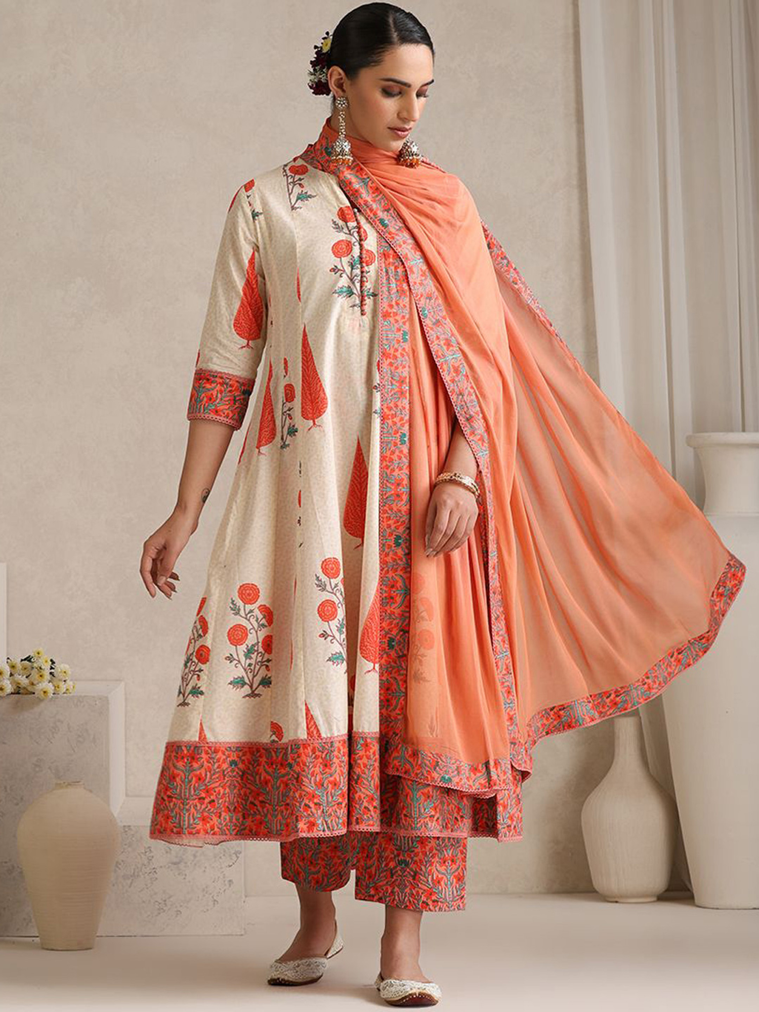Elegant three-piece silk blend kurta set with floral patterns and an orange dupatta