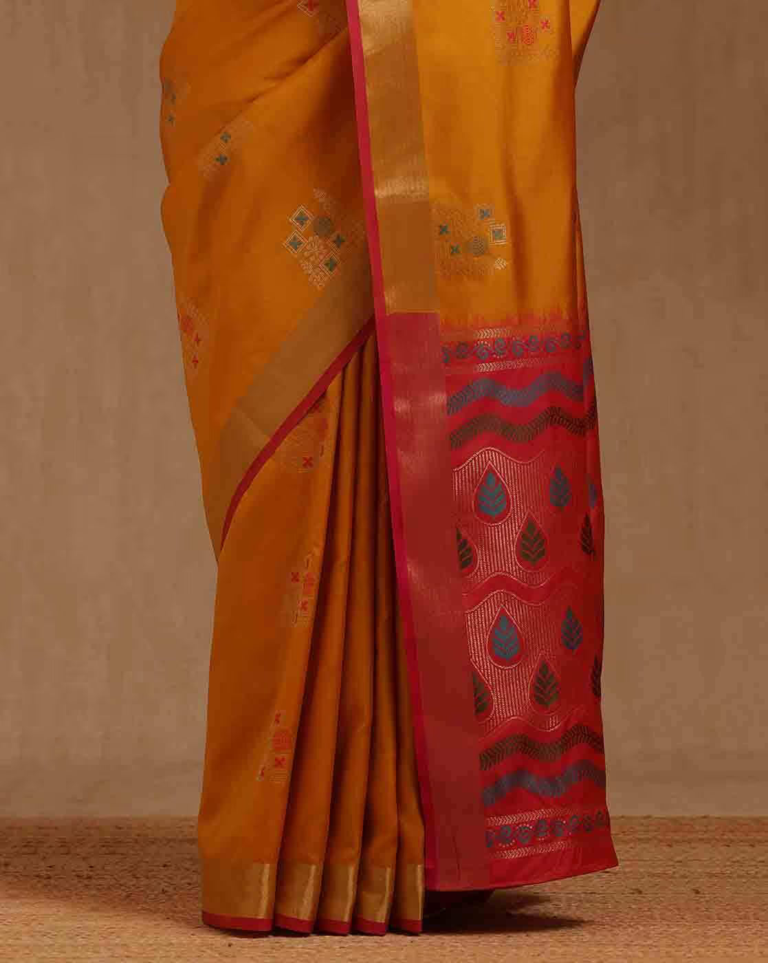 Front view of a silk blend saree Canda in vibrant yellow with red detailing, perfect for festive occasions