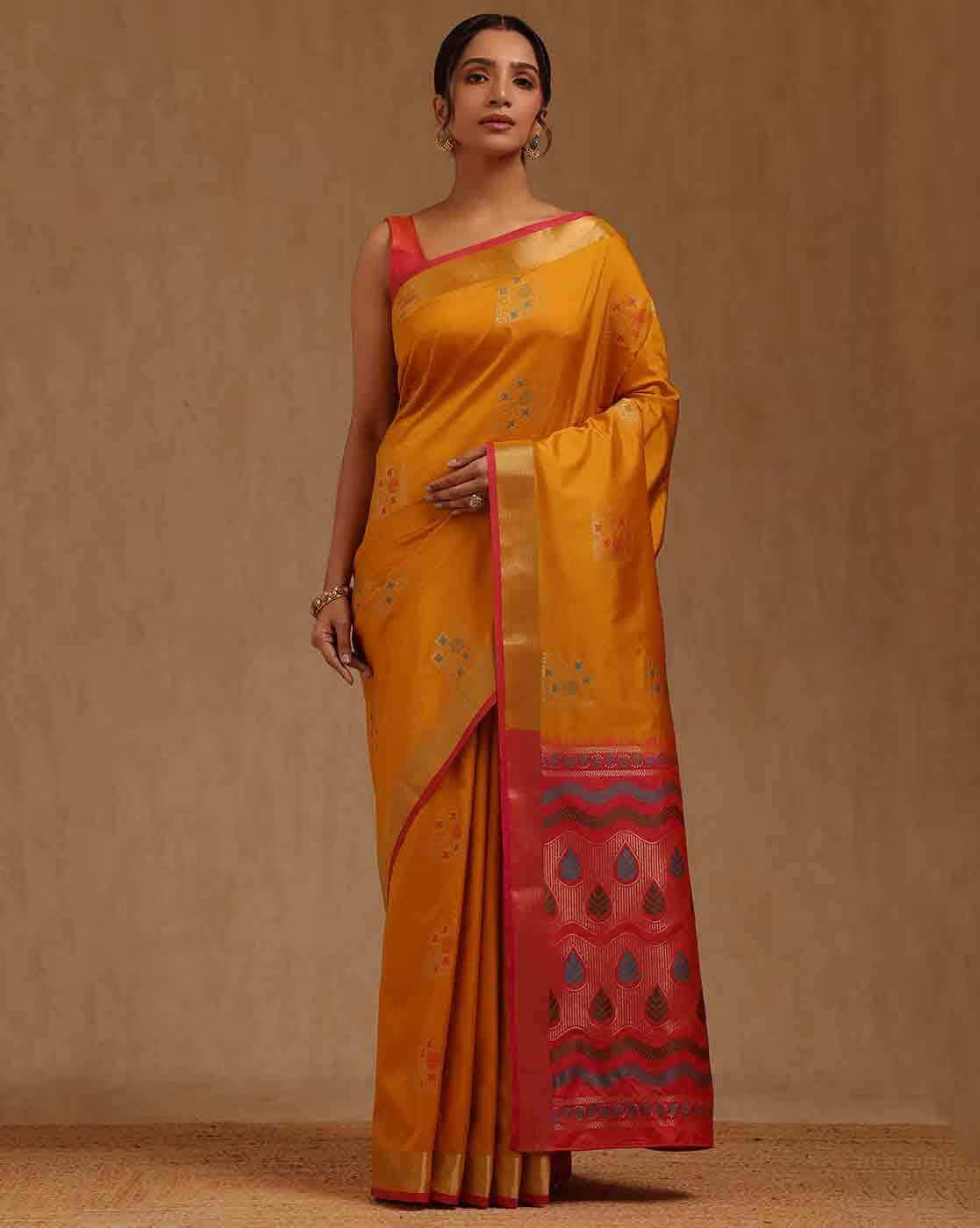 Front view of a silk blend saree Canda in vibrant yellow with red accents, perfect for festive occasions.