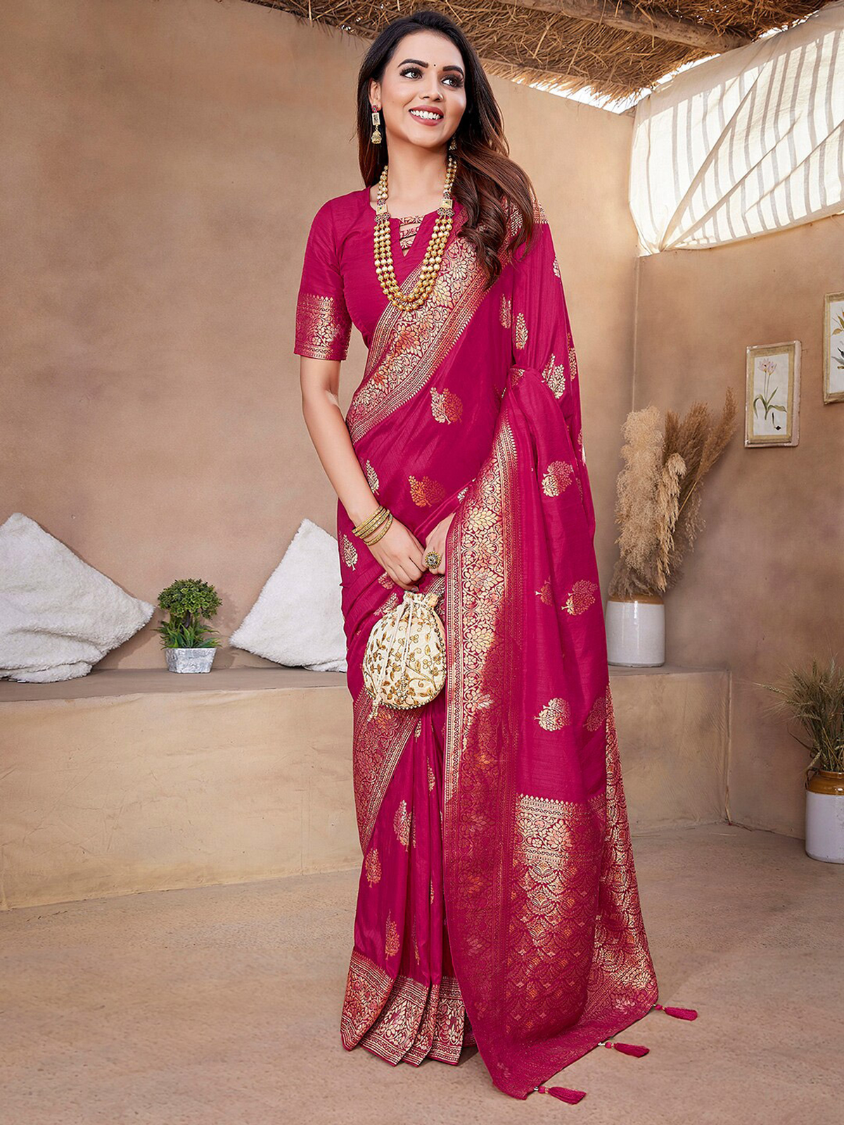 Front view of a pink silk saree from Aromie, embellished with gold motifs, perfect for weddings and festive occasions