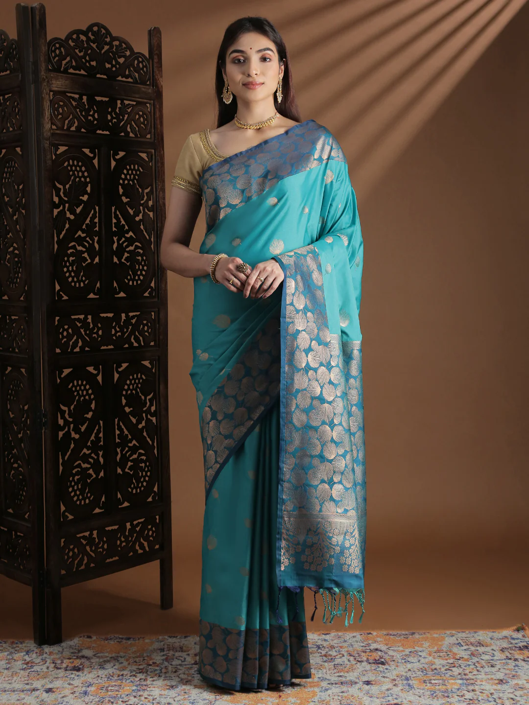 Elegant turquoise soft silk saree Canada featuring gold circular patterns, ideal for festive occasions