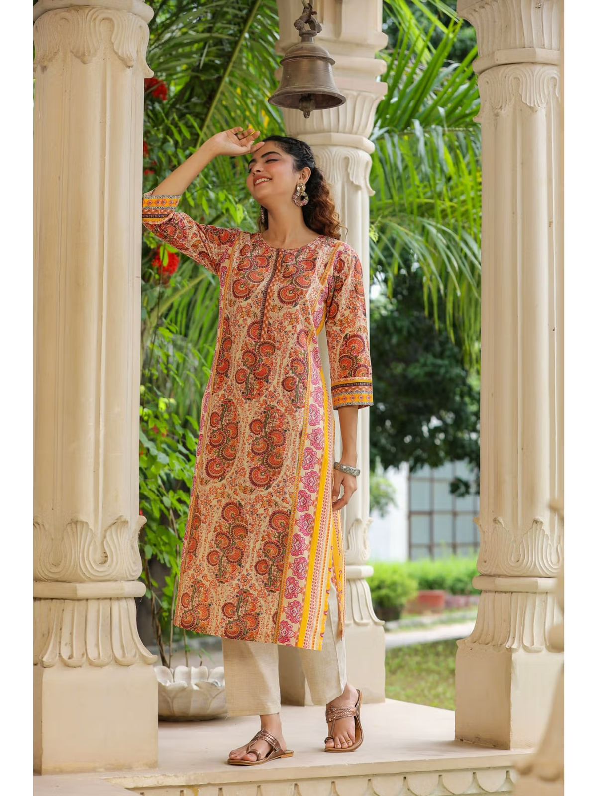 Aromie Fusion Wear flared jumpsuit for women styled as printed kurta with beige pants and sandals outdoors