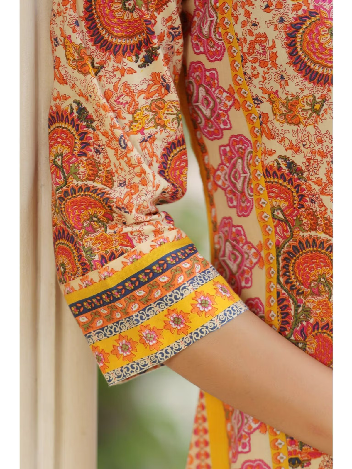 Aromie Fusion Wear close up of printed sleeve and cuff in orange pink paisley flared jumpsuit for women