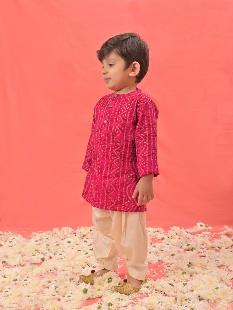 infant boys pink kurta patiala set with patterned magenta kurta and cream patiala pants on floral floor