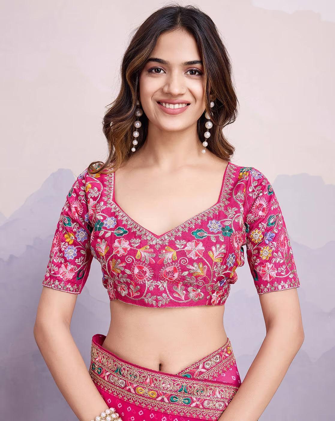 Elegant pink tissue saree for parties paired with a stylish embroidered blouse and pearl earrings