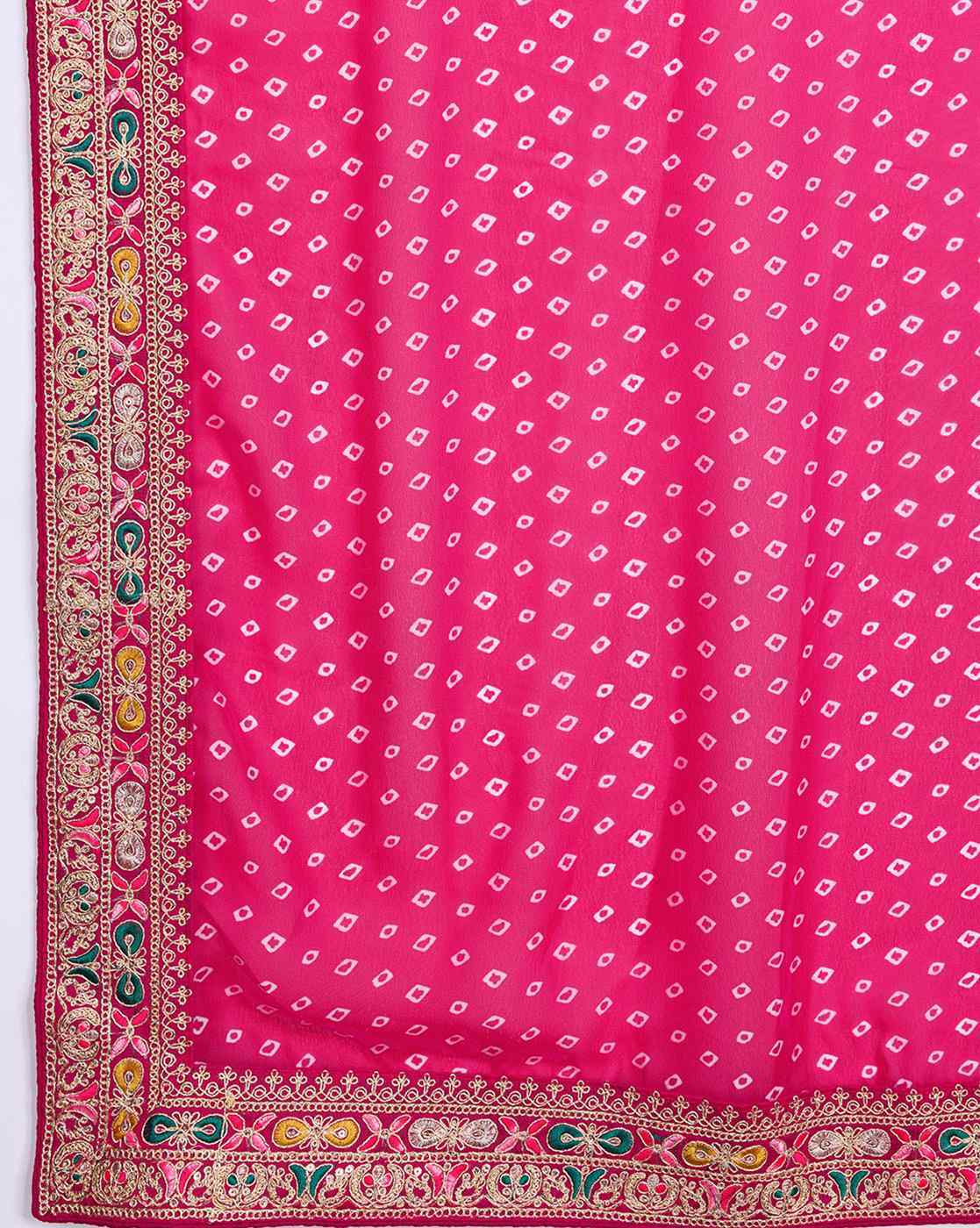 Vibrant pink tissue saree for parties with intricate border detailing and a beautiful design