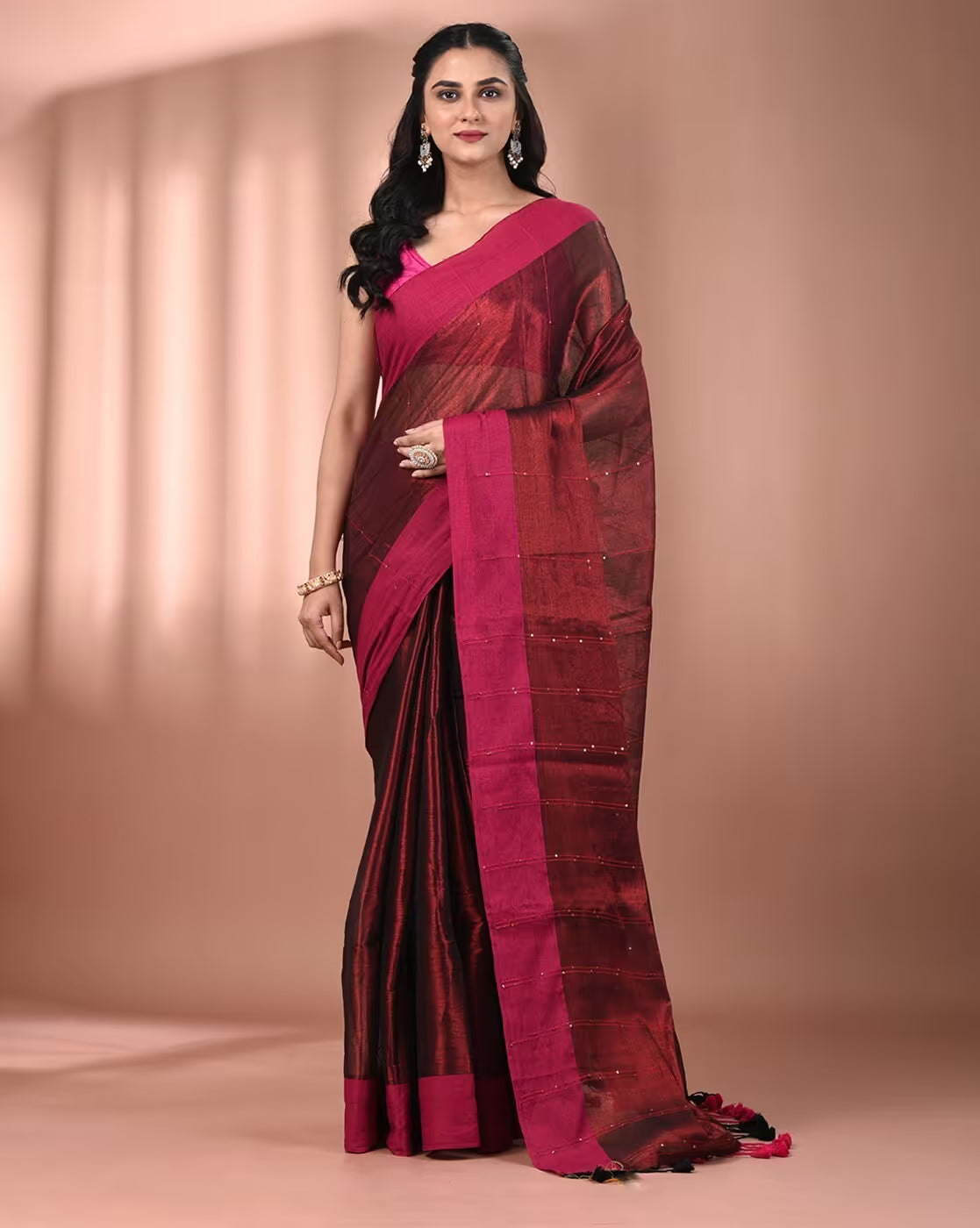 Elegant maroon tissue saree with intricate detailing, perfect for weddings and special occasions. Front view.