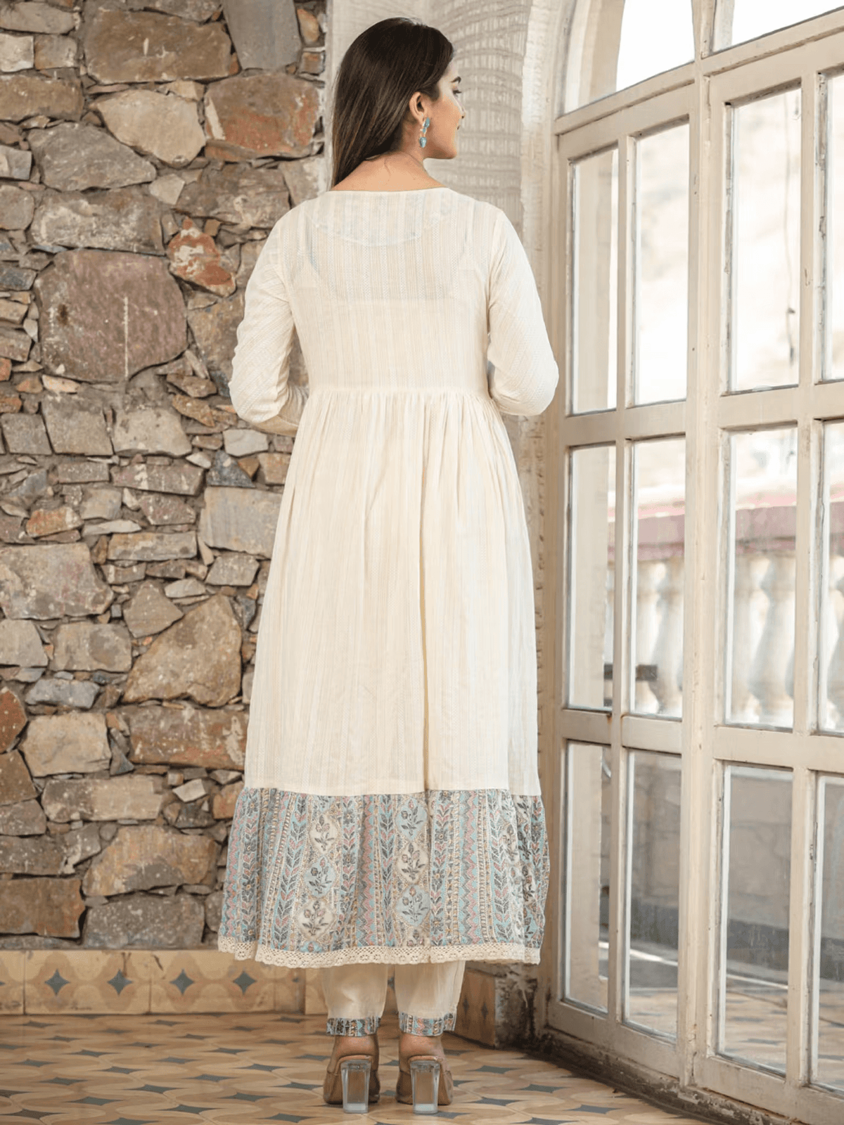 Floral Anarkali kurta pants set in cream with patterned hem and elegant design for festive occasions
