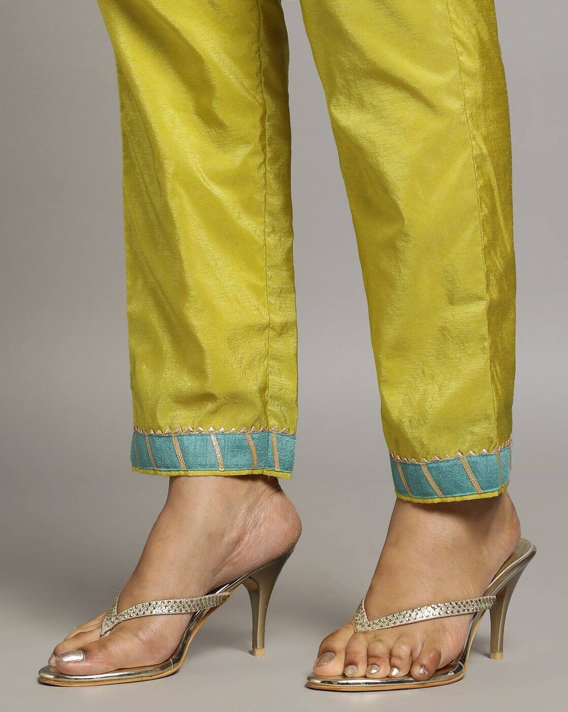 Close-up of yellow three piece Kurtha pant with blue embroidered cuffs paired with beige high heel sandals Georgette Anarkali Gown Canada