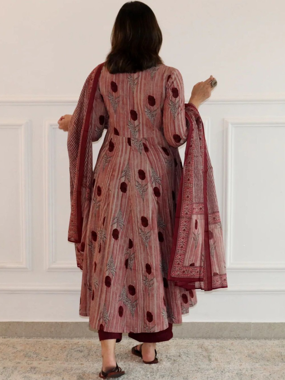 Back view of a pink floral anarkali kurta palazzo set with rich detailing and elegant design