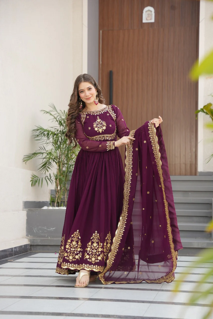 Wine georgette gown with dupatta in front view, embellished with gold embroidery for festive occasions