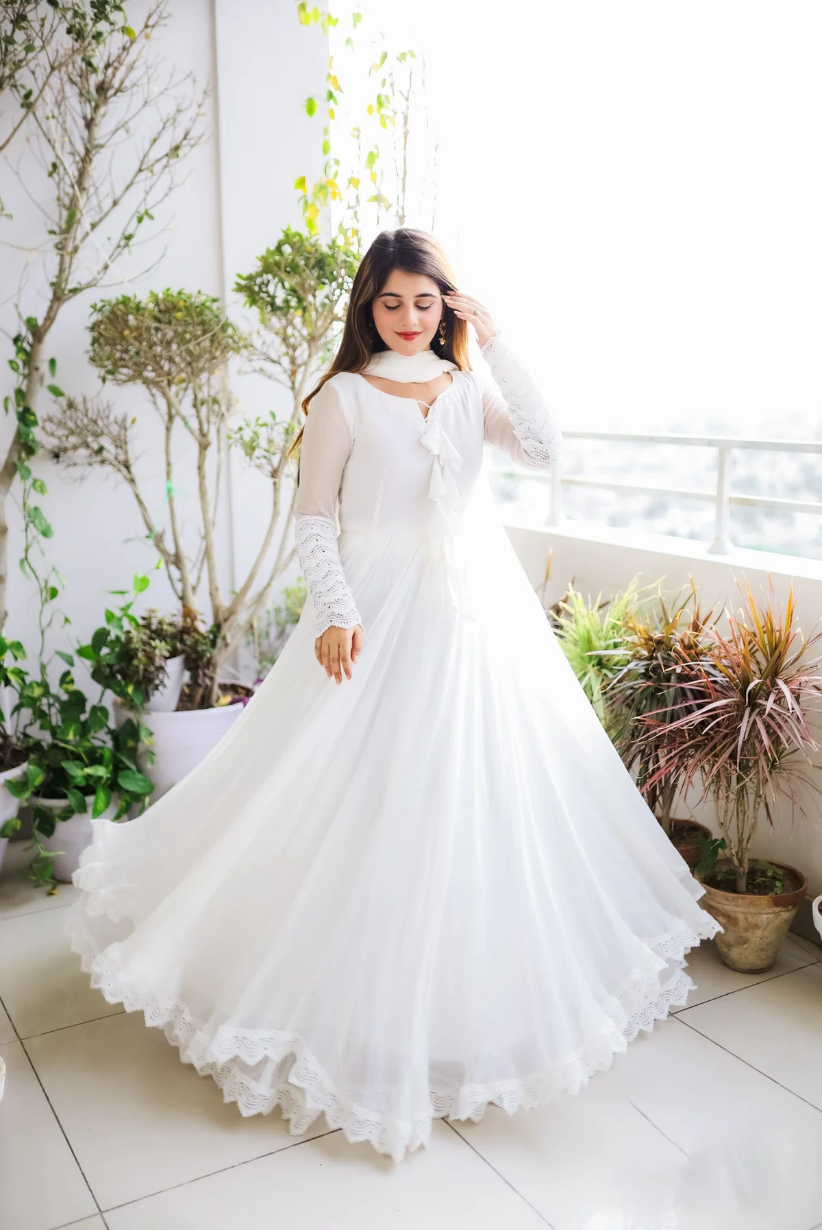 Elegant white double layered anarkali with dupatta, perfect for weddings, made from soft flowing fabric, front view.