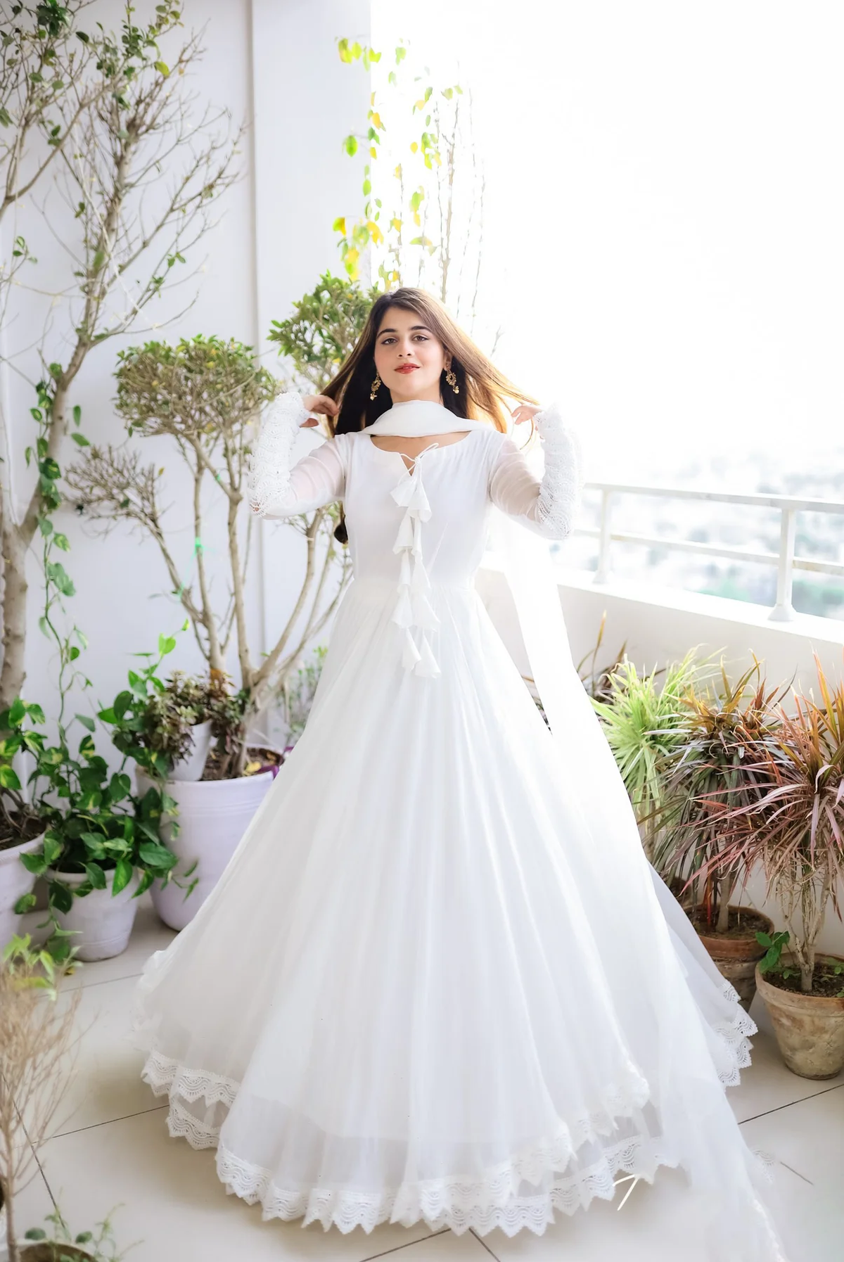 Elegant white double layered anarkali with dupatta made of soft fabric, ideal for weddings and festive occasions