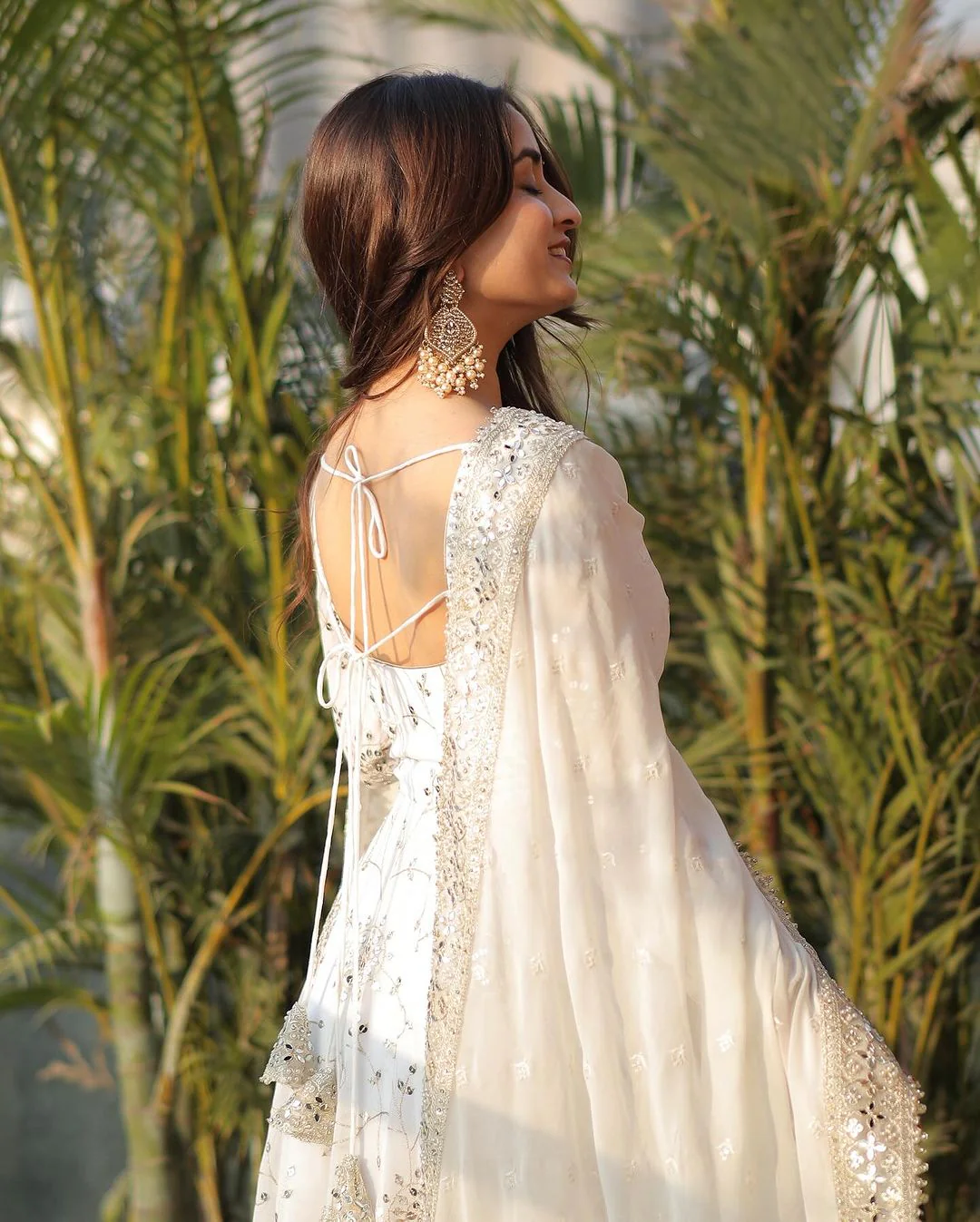 Elegant white georgette anarkali gown with intricate detailing and an elegant back design