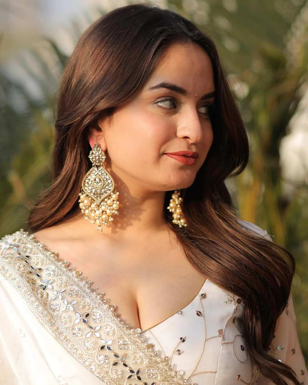 Aromie white georgette anarkali gown with intricate embroidery and elegant embellishments