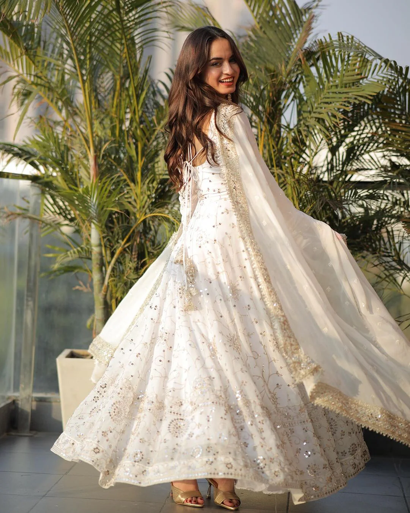 Elegant white georgette anarkali gown with sequins and intricate details, perfect for special occasions