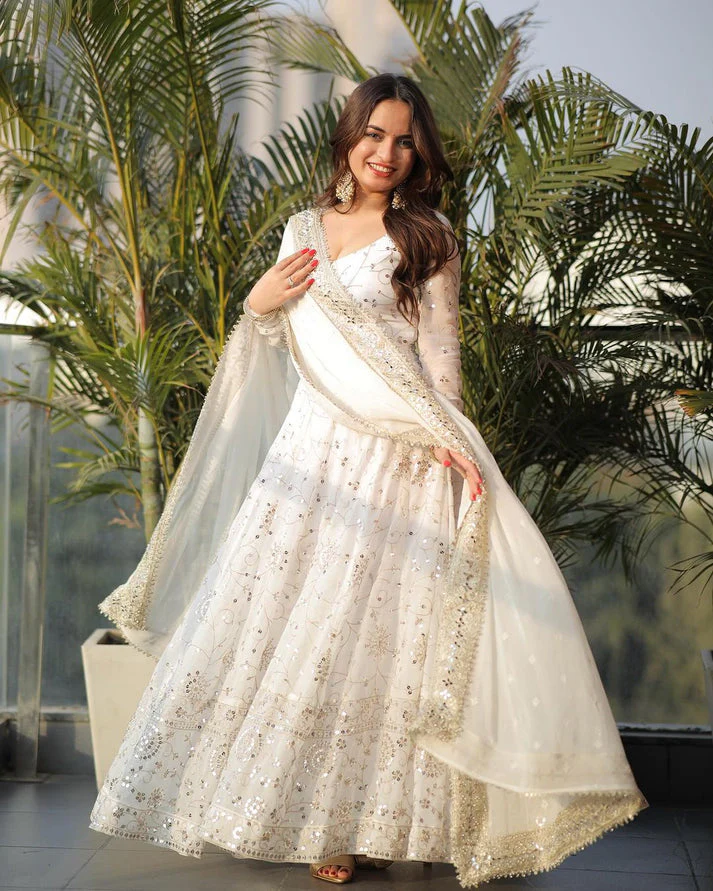 Elegant white georgette anarkali gown with intricate embellishments and flowing cape, perfect for special occasions