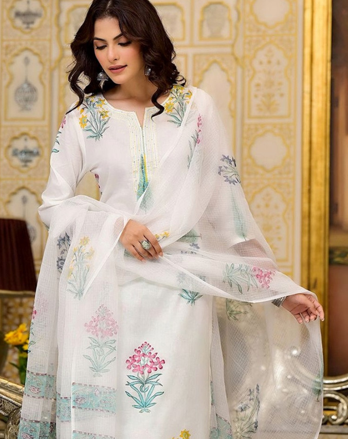 Front view of a white printed kurta trouser set with dupatta, featuring vibrant floral designs, perfect for festive occasions.