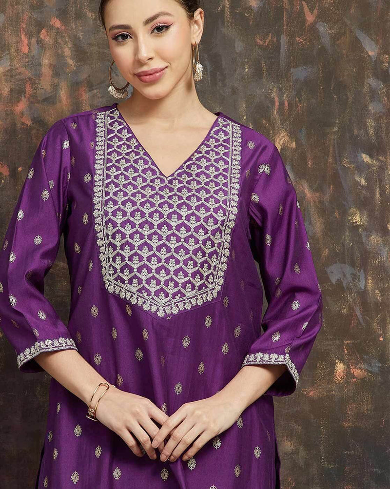 Purple women's embroidered kurta suit set with intricate silver detailing and stylish V-neck design